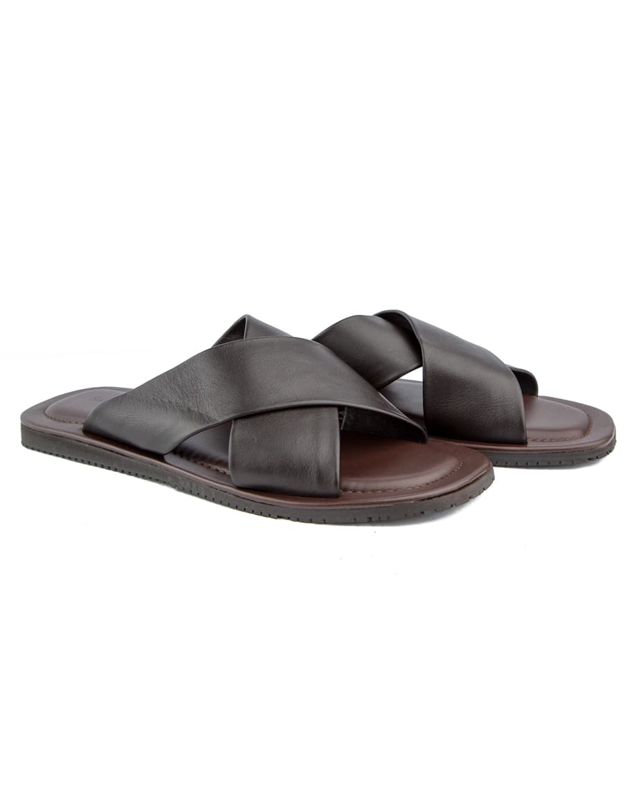 Elegant black cross-strap leather sandals with cushioned footbed and durable rubber sole, offering both comfort and style for casual and semi-formal wea