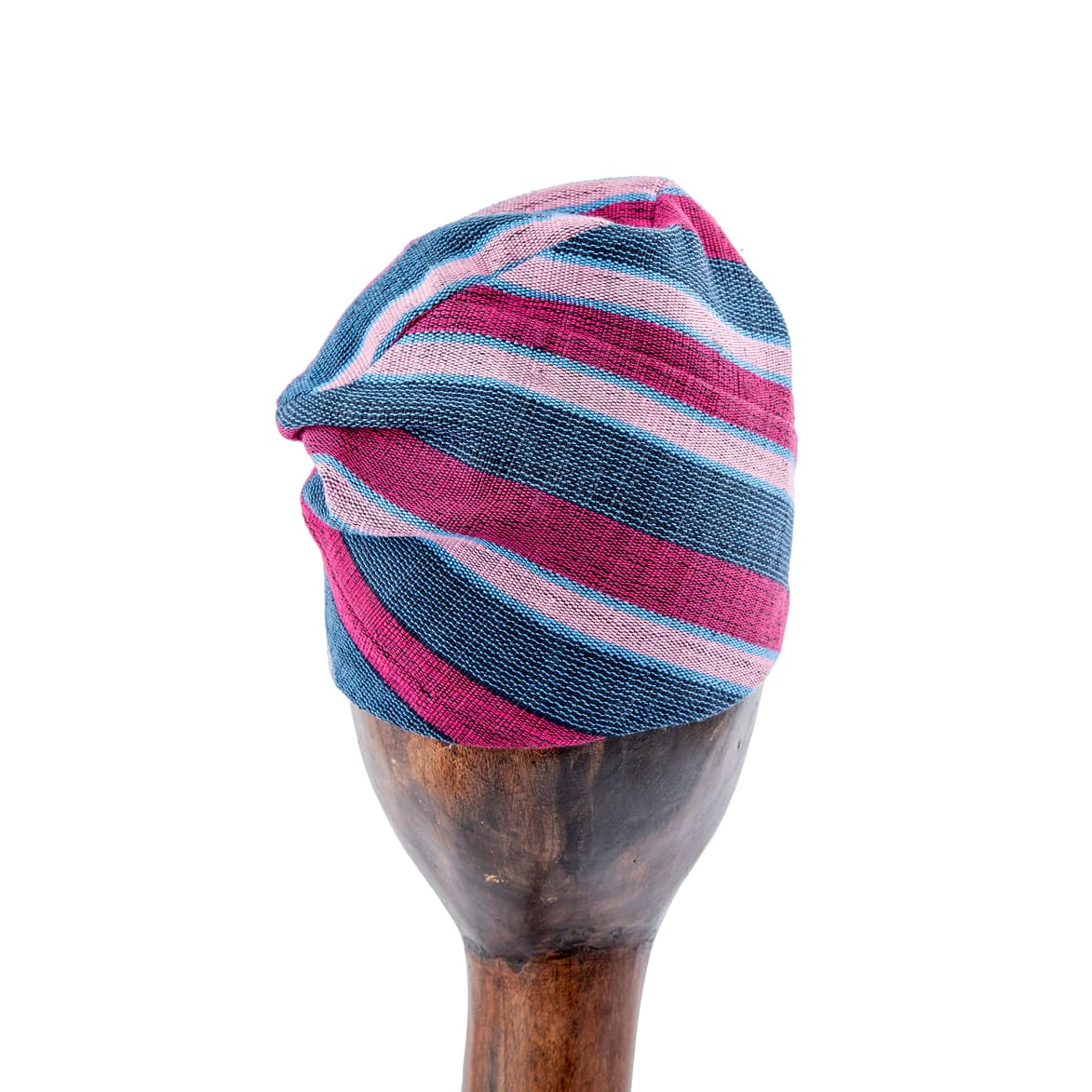 This Unisex Aso-Oke Cap/ Hat  is a stylish and cozy winter accessory featuring a striped pattern in pink, blue, and gray, crafted from a soft cotton knit fabric