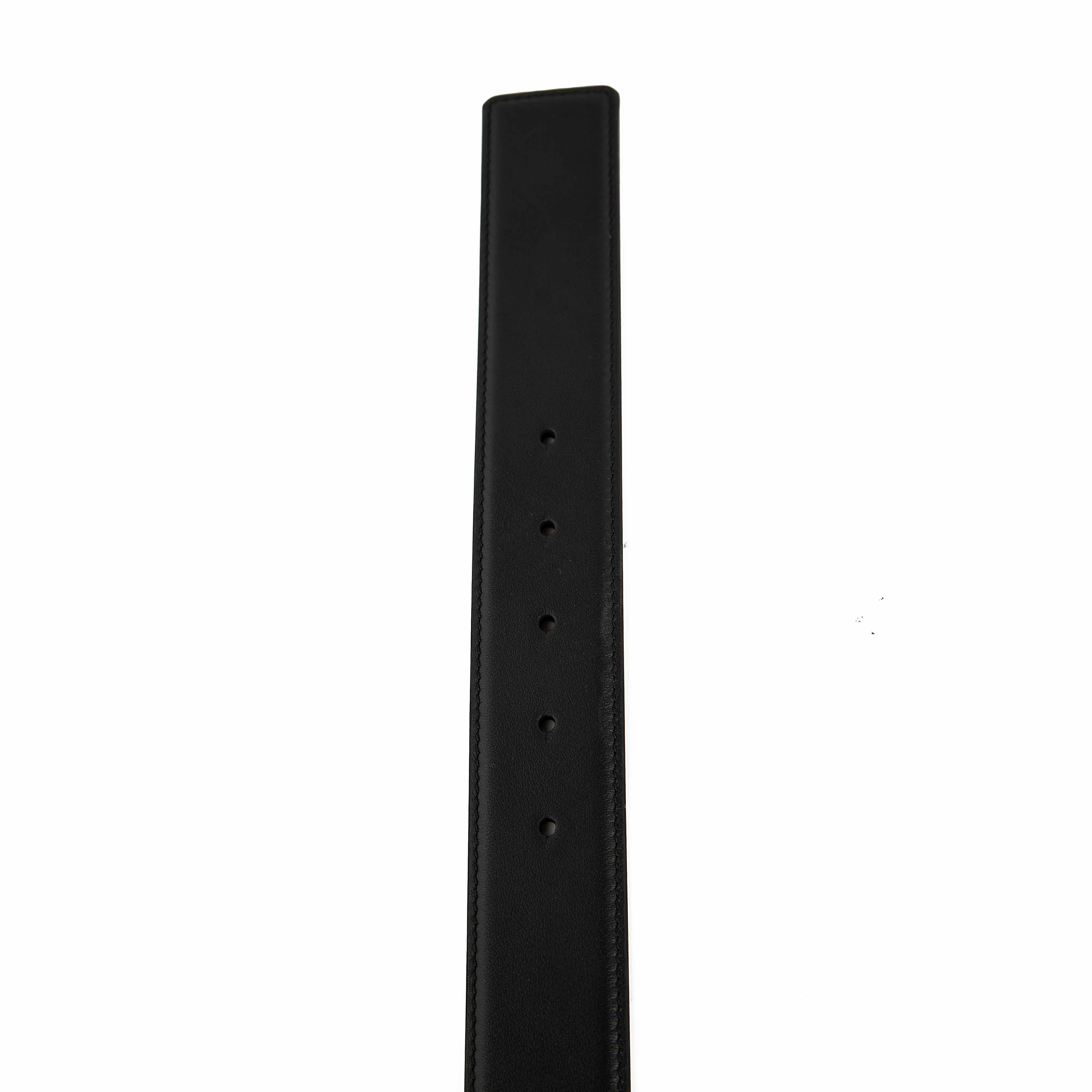 This accessory is a premium Black Leather Belt that makes a bold, luxurious statement.