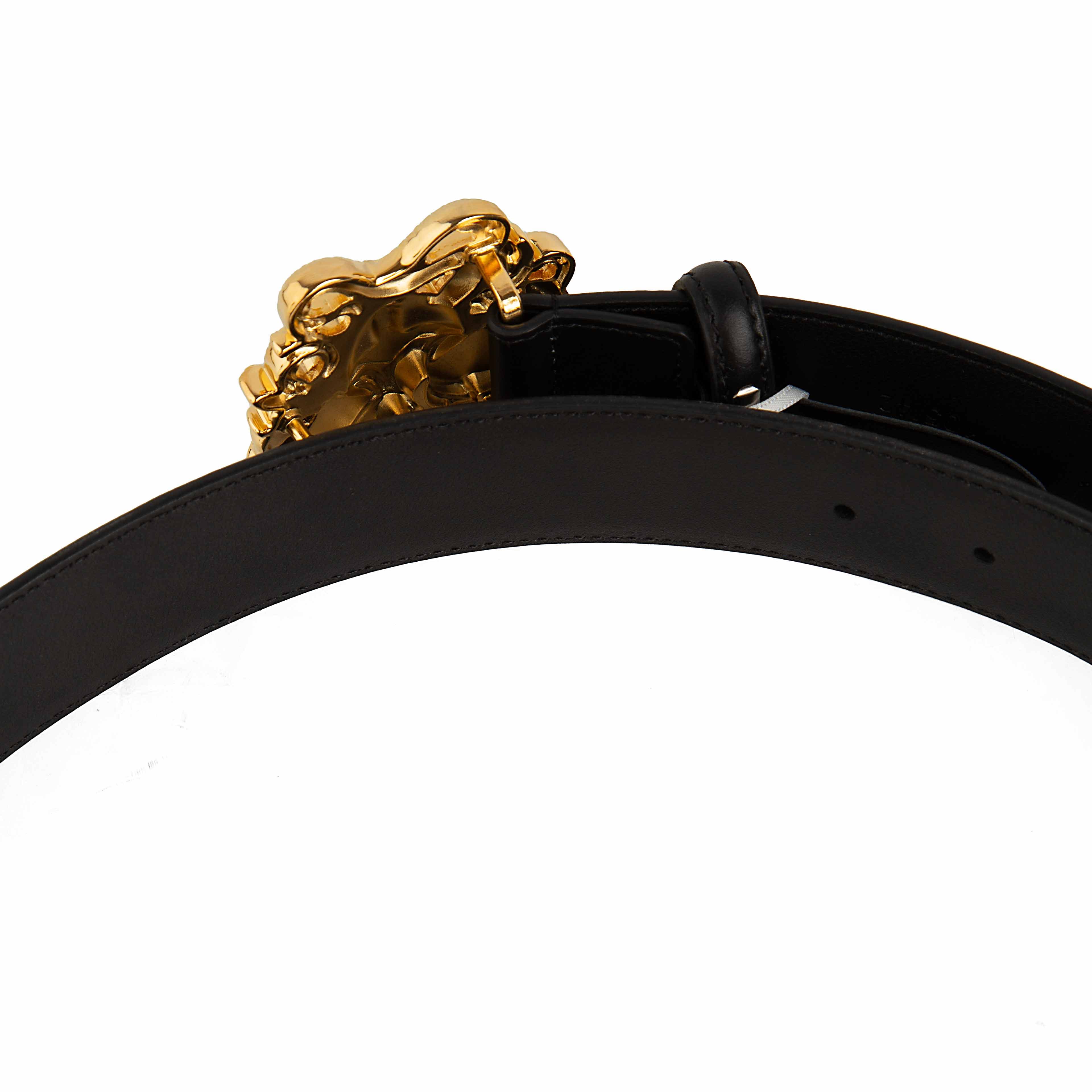 This accessory is a smooth black leather belt that serves as a bold statement piece.