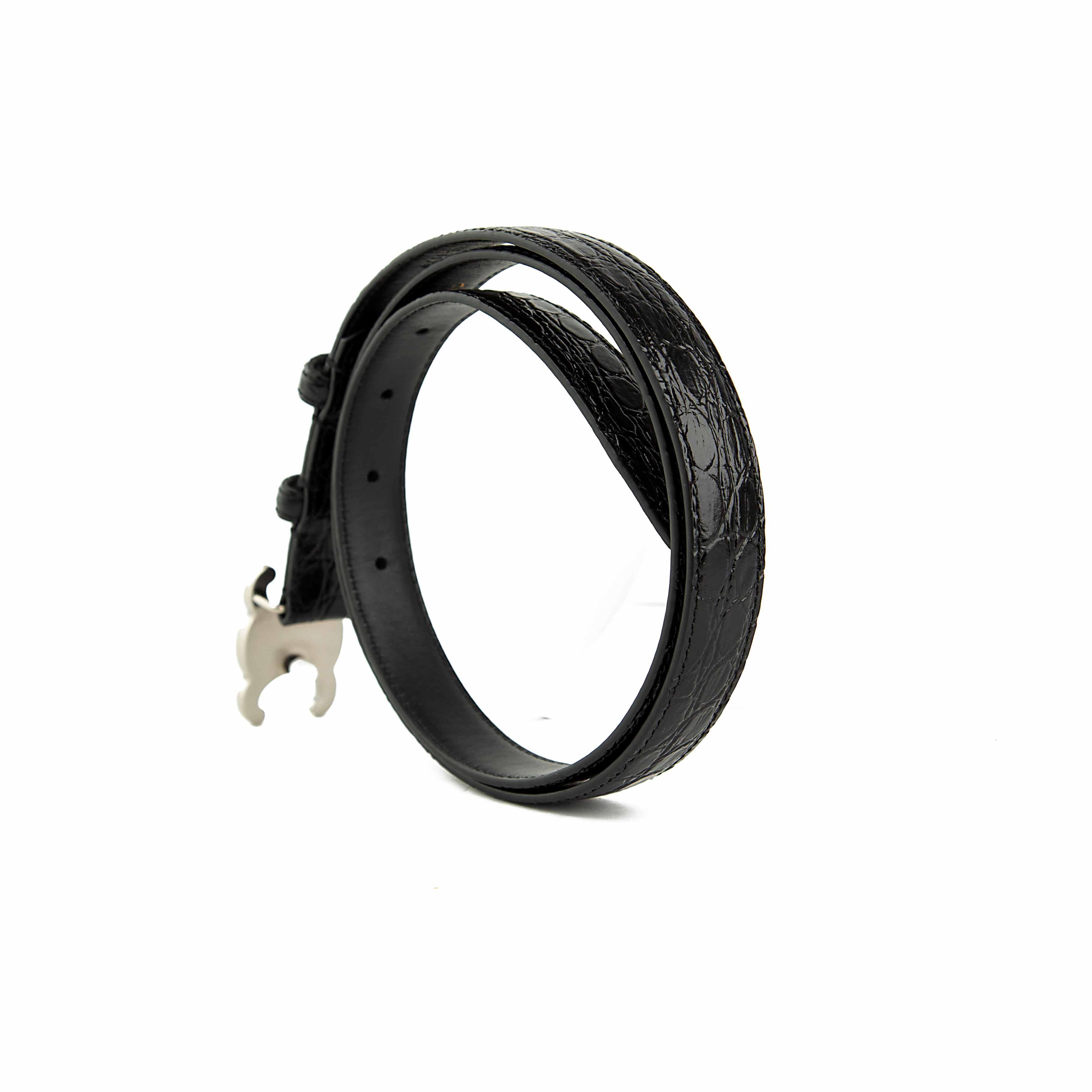 This elegant accessory is a masterclass in understated luxury, featuring a smooth, semi-matte black calfskin leather strap.