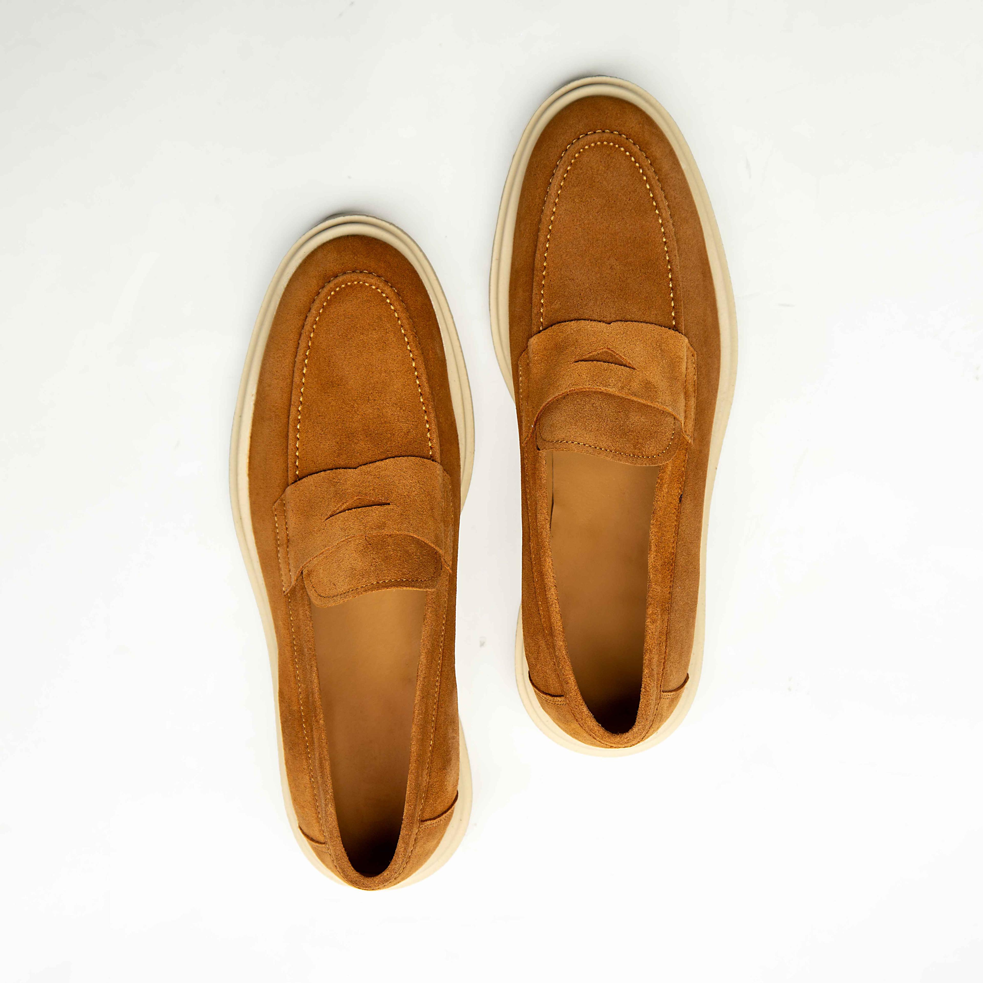 Agu & Sons Ltd tobacco tan suede penny loafers with thick cream-colored chunky rubber soles on a white background.