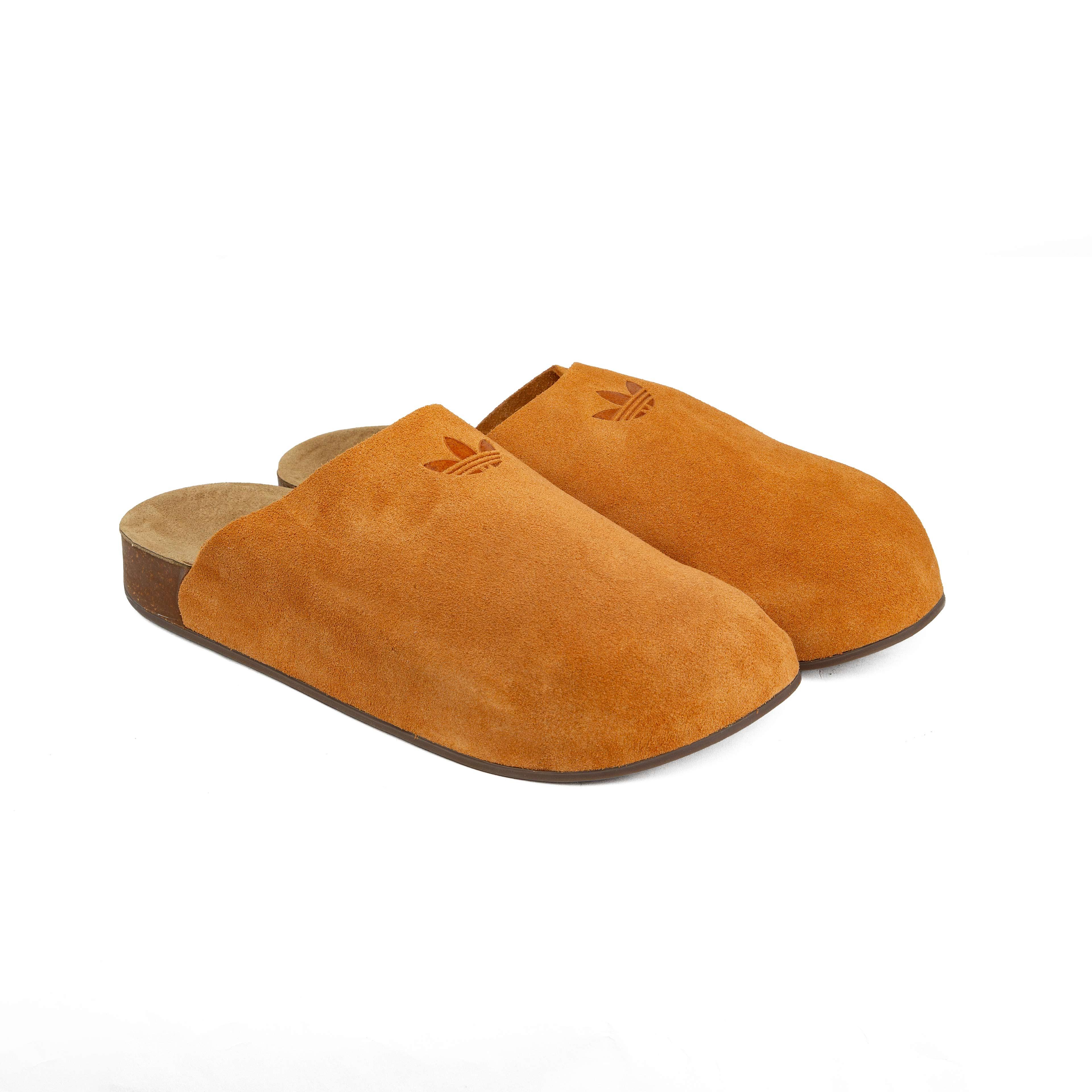Elevate your comfort with our Suede Trefoil Clogs in Amber.