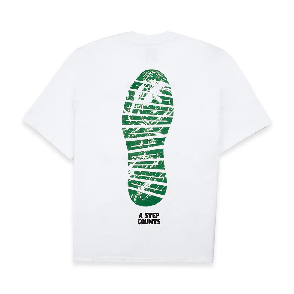 White t-shirt with green footprint graphic and "A Step Counts" text. Unique graphic tee.