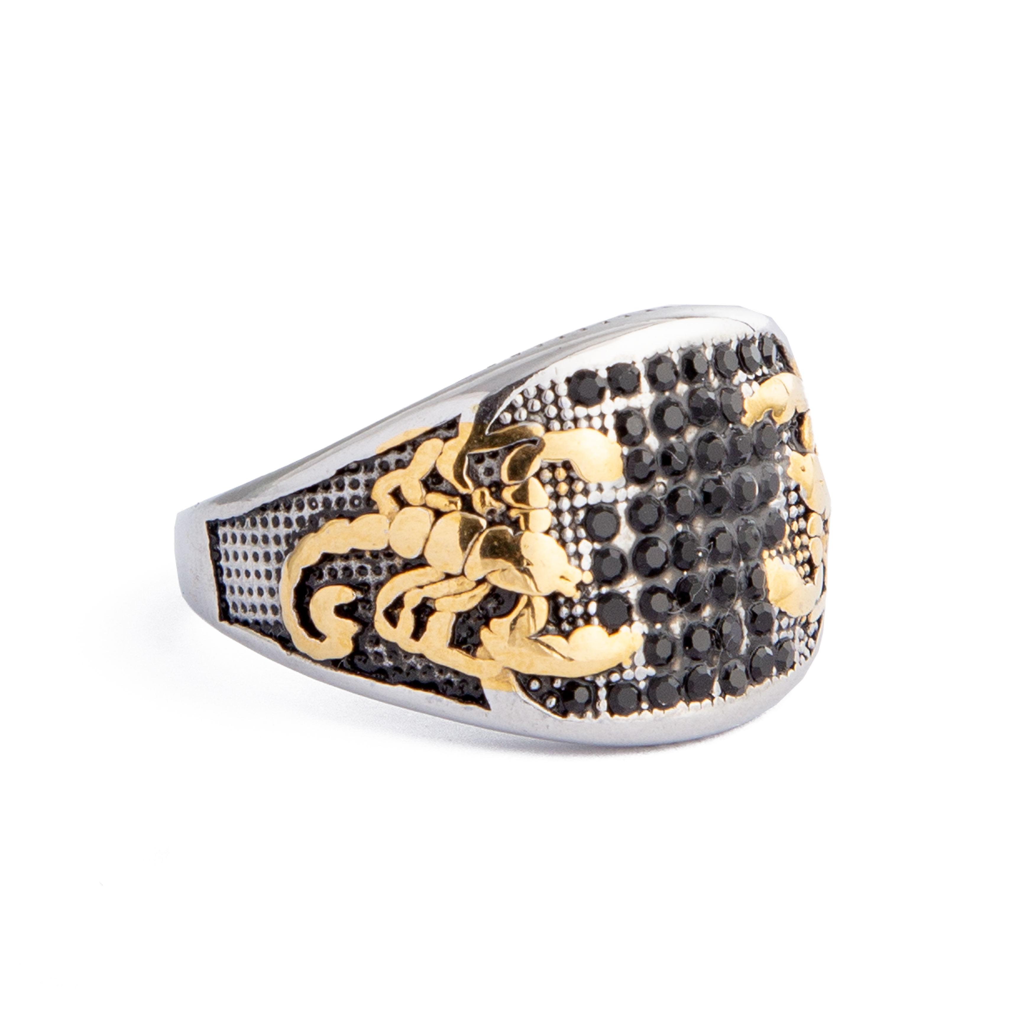 Silver and gold statement ring featuring a scorpion design with black stone accents.
