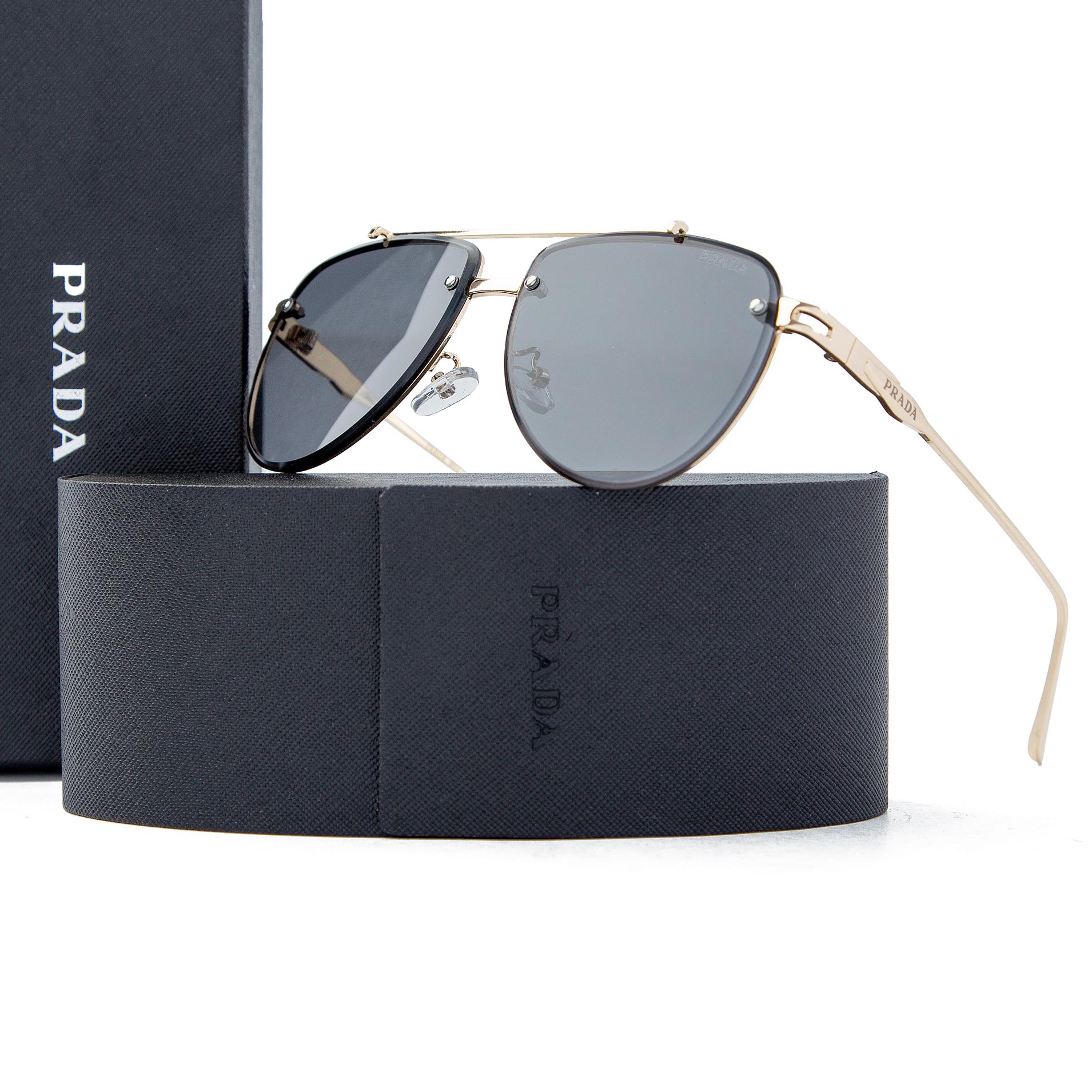 Prada gold aviator sunglasses with dark gray lenses, featuring a luxury gold-tone metal frame and Prada branding, offering UV protection and timeless style