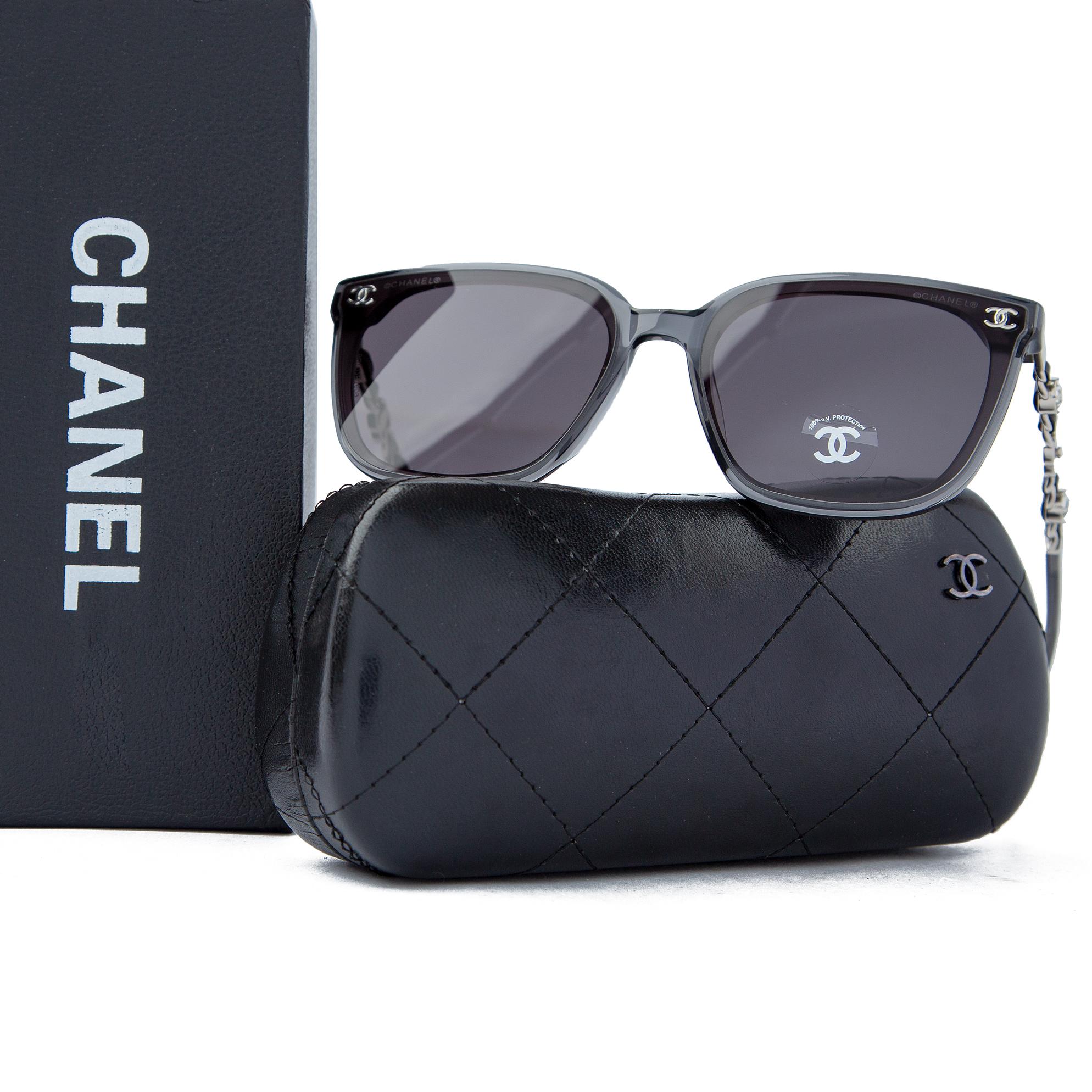 Chanel grey transparent square sunglasses for men with logo chain temples, luxurious eyewear offering UV protection and a modern, stylish look.