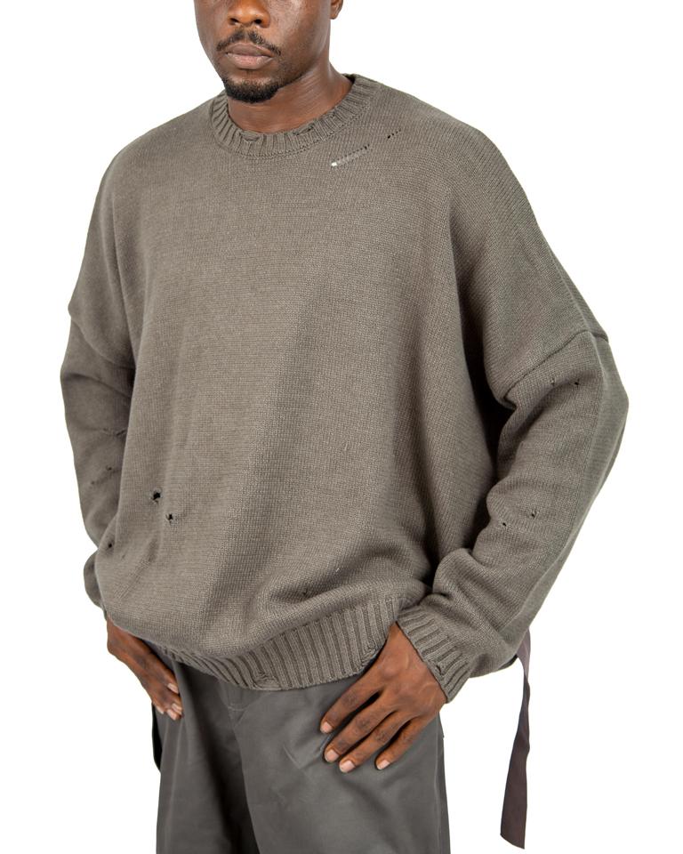 Distressed brown knit sweater with ribbed cuffs and hem.