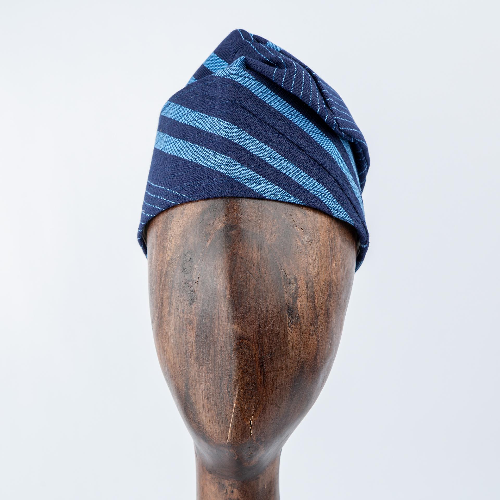 Unisex navy blue Aso Oke cap with diagonal light blue stripe design, premium handwoven traditional headwear for weddings, events, and special occasions
