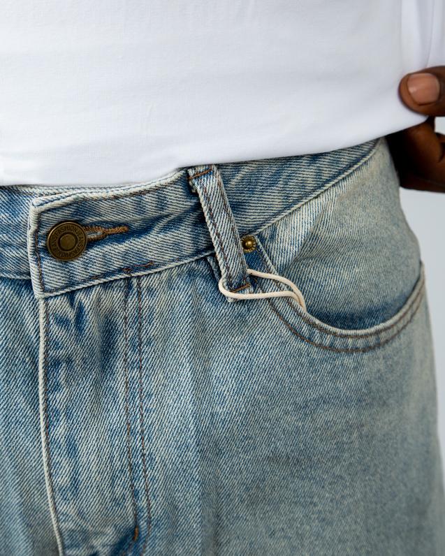 Vintage washed loose-fit denim jeans in light blue. Stylish, comfortable, and perfect for casual outfits. Unisex design with a relaxed, retro feel.