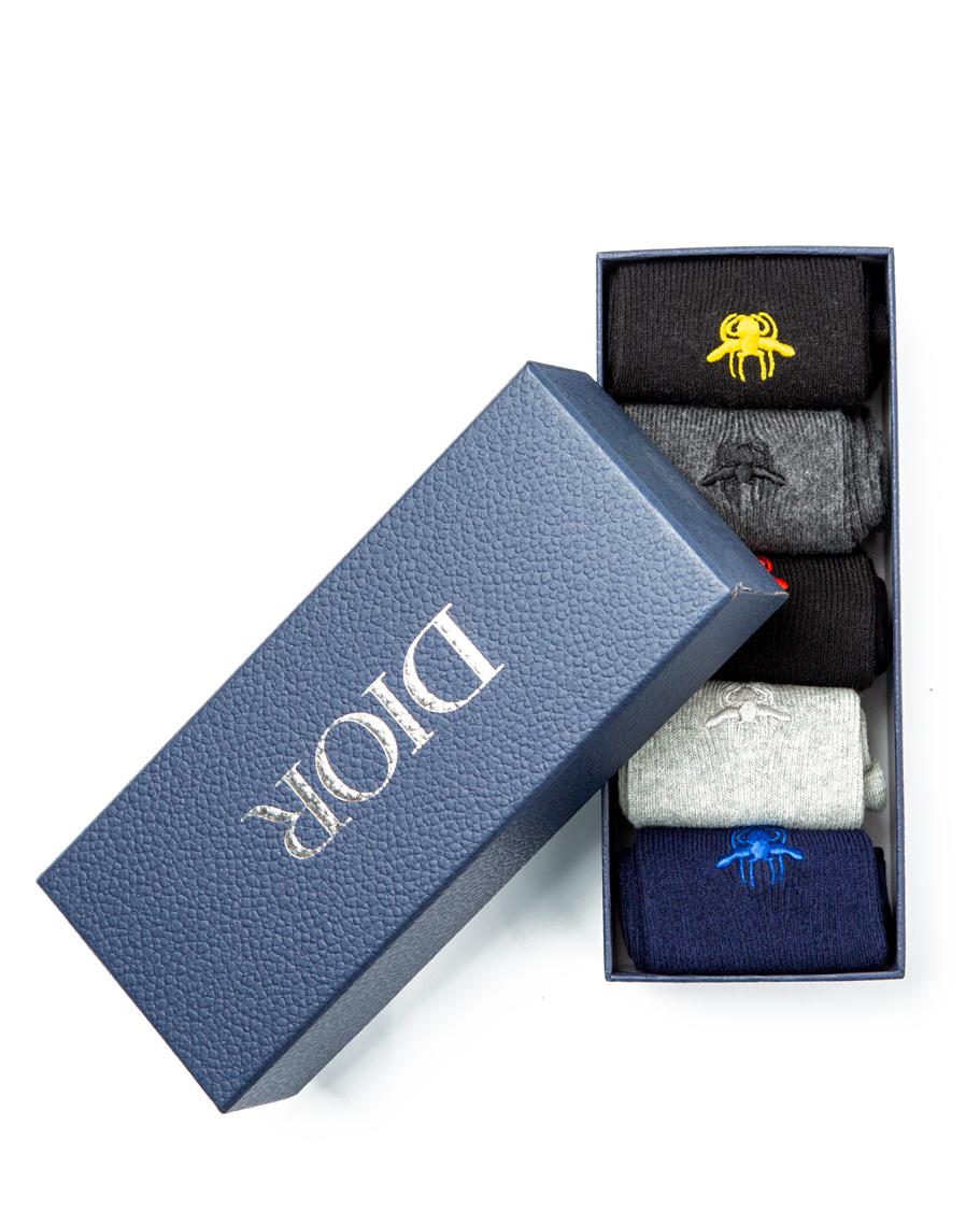 Dior Bee Motif Socks Multi-Pack, featuring black, dark grey, light grey, and navy pairs with embroidered bee detail and ribbed design