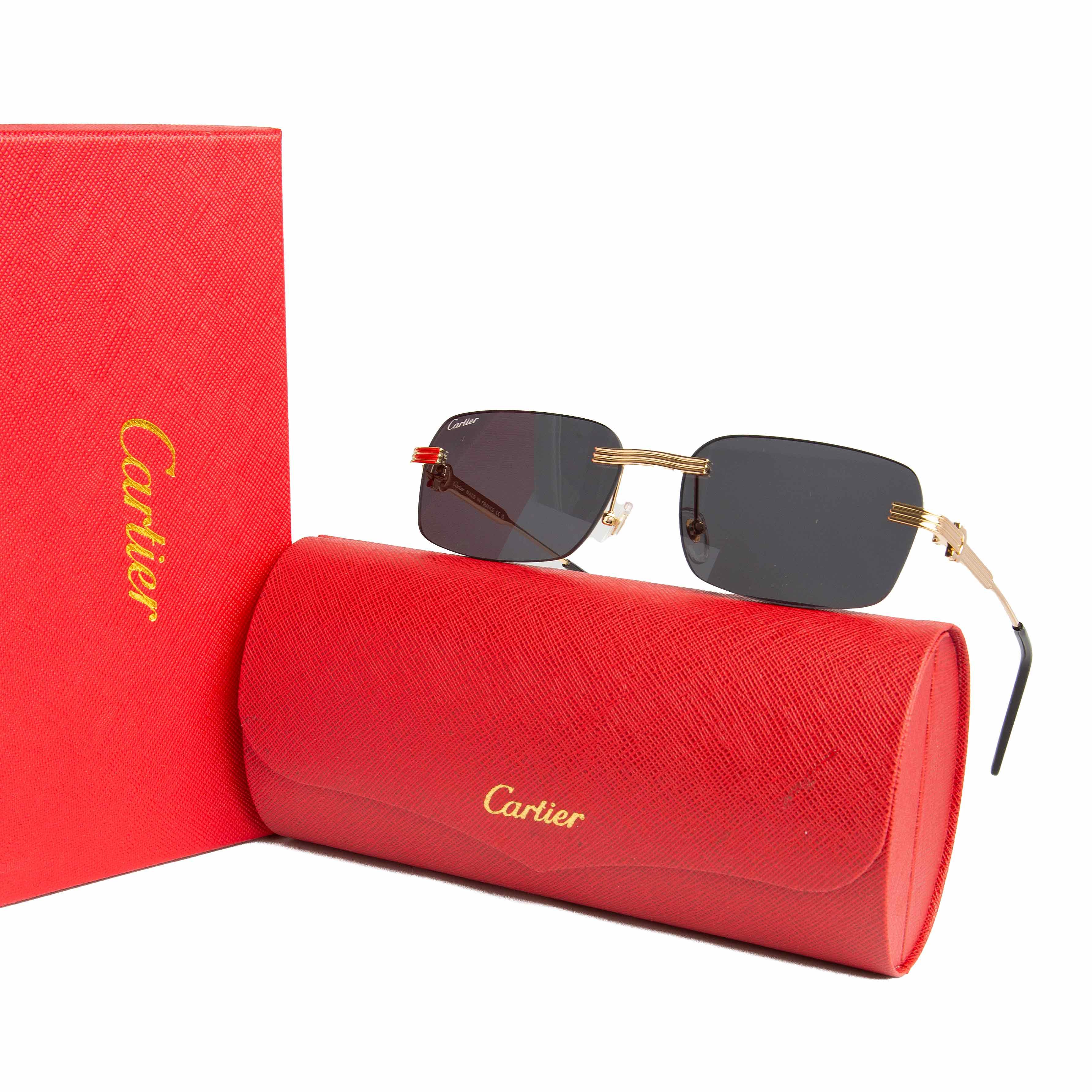 Cartier rimless grey lens rectangular sunglasses with gold-tone accents. Luxury eyewear for men and women.