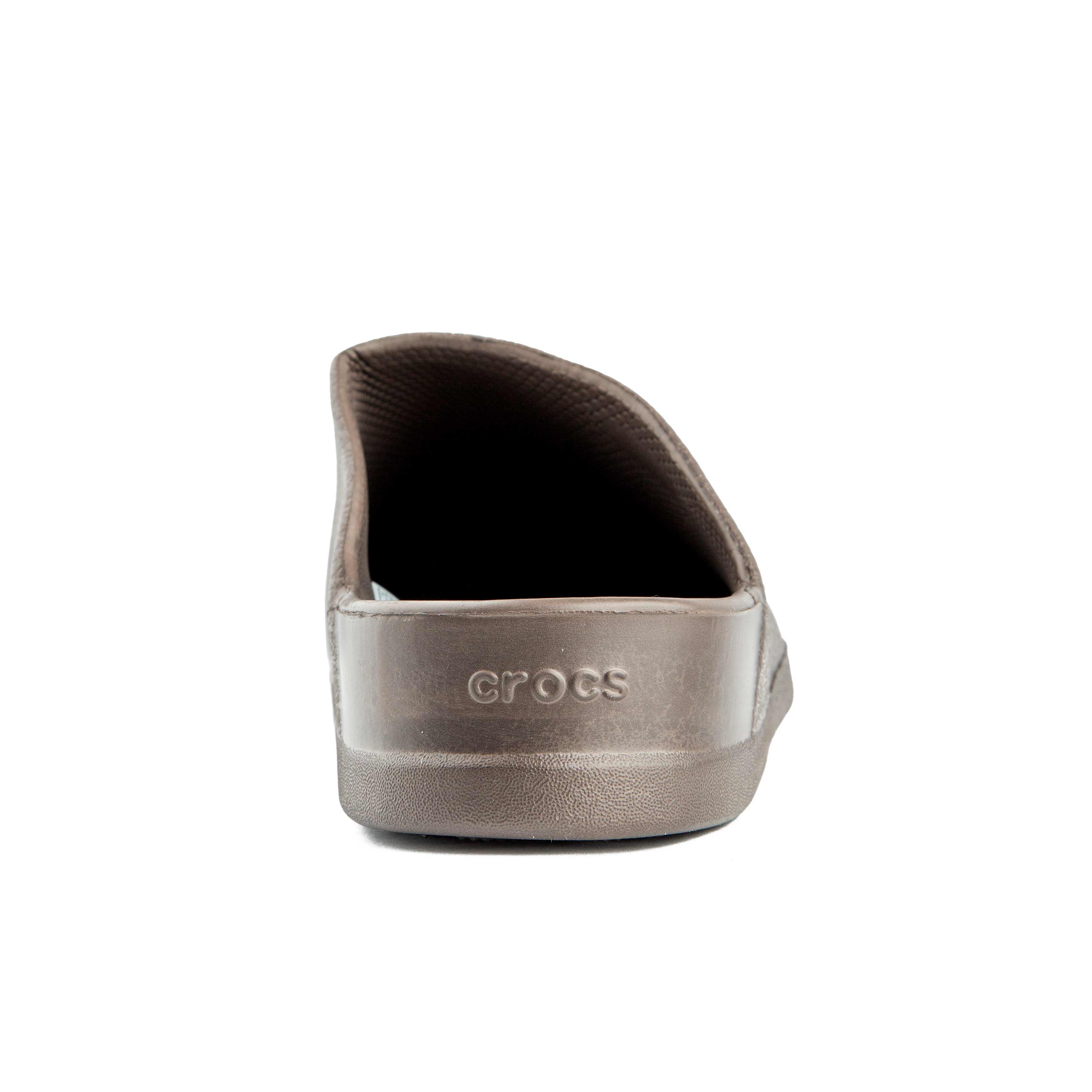 This is a pair of closed-toe, unvented clogs in a solid brown color from the Crocs brand.