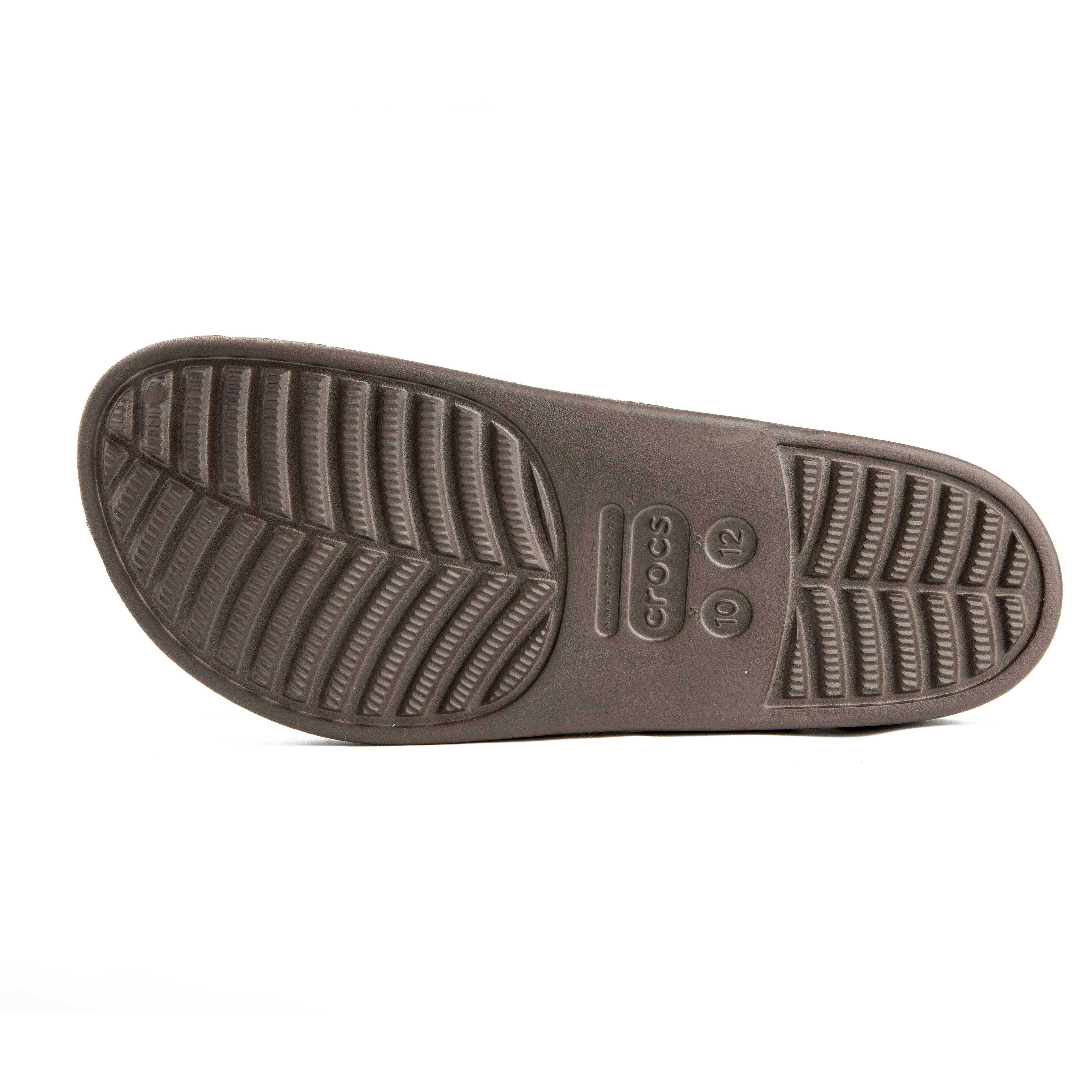 This is a pair of closed-toe, unvented clogs in a solid brown color from the Crocs brand.