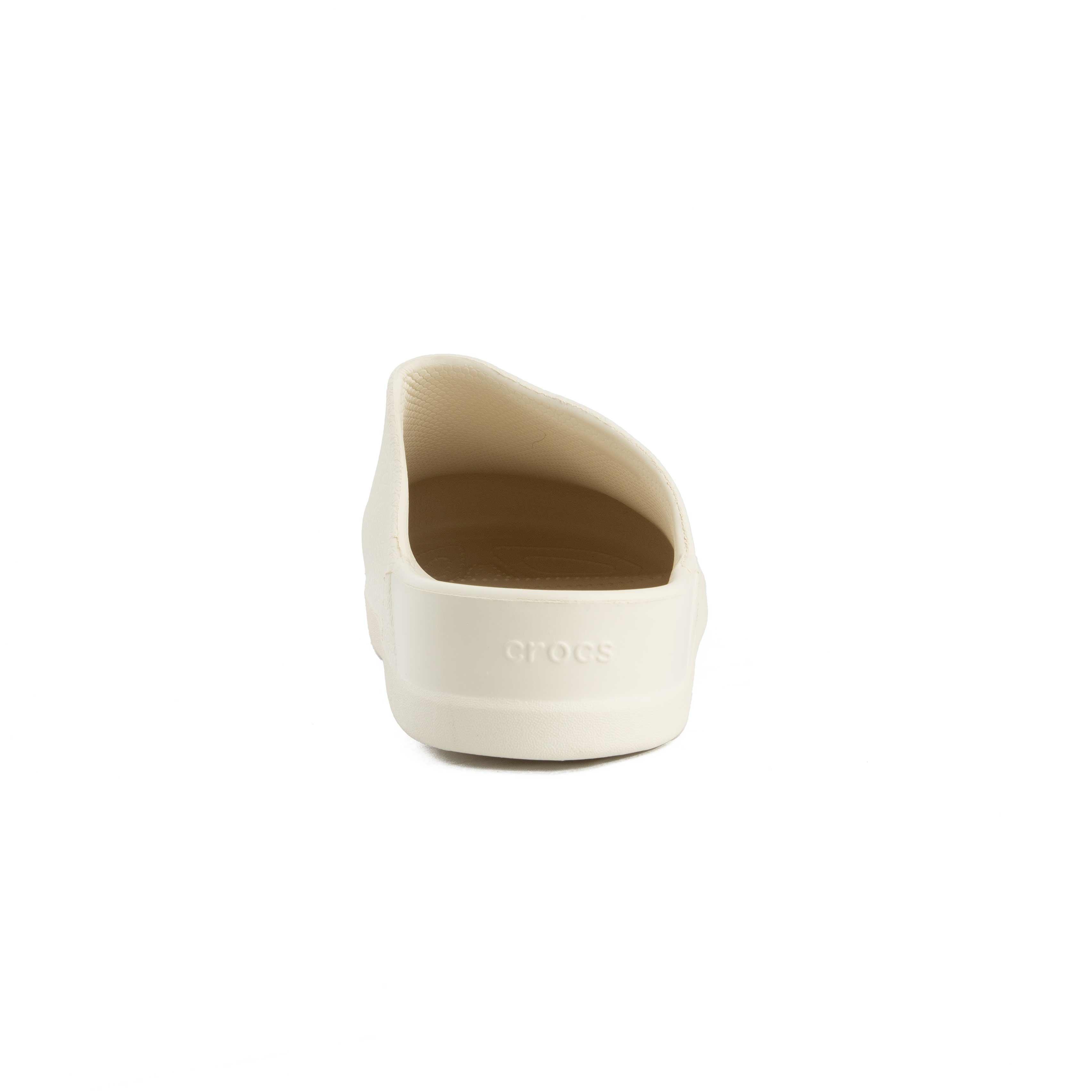 This is a pair of closed-toe, unvented clogs from the Crocs brand, presented in a soft, off-white color. 