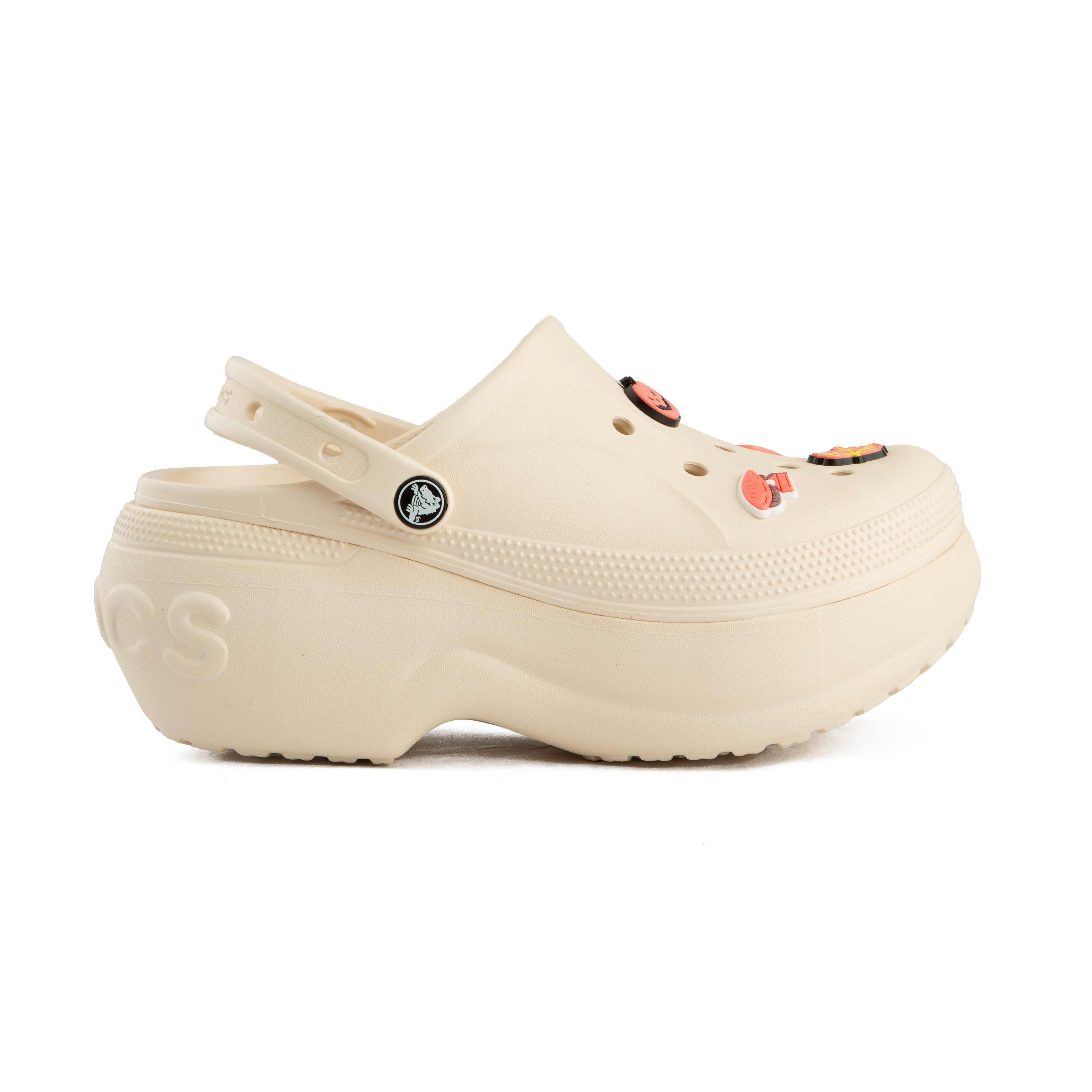 This is a pair of light beige/cream Crocs Classic Platform Clogs, featuring the brand's iconic design with an elevated, chunky sole. 