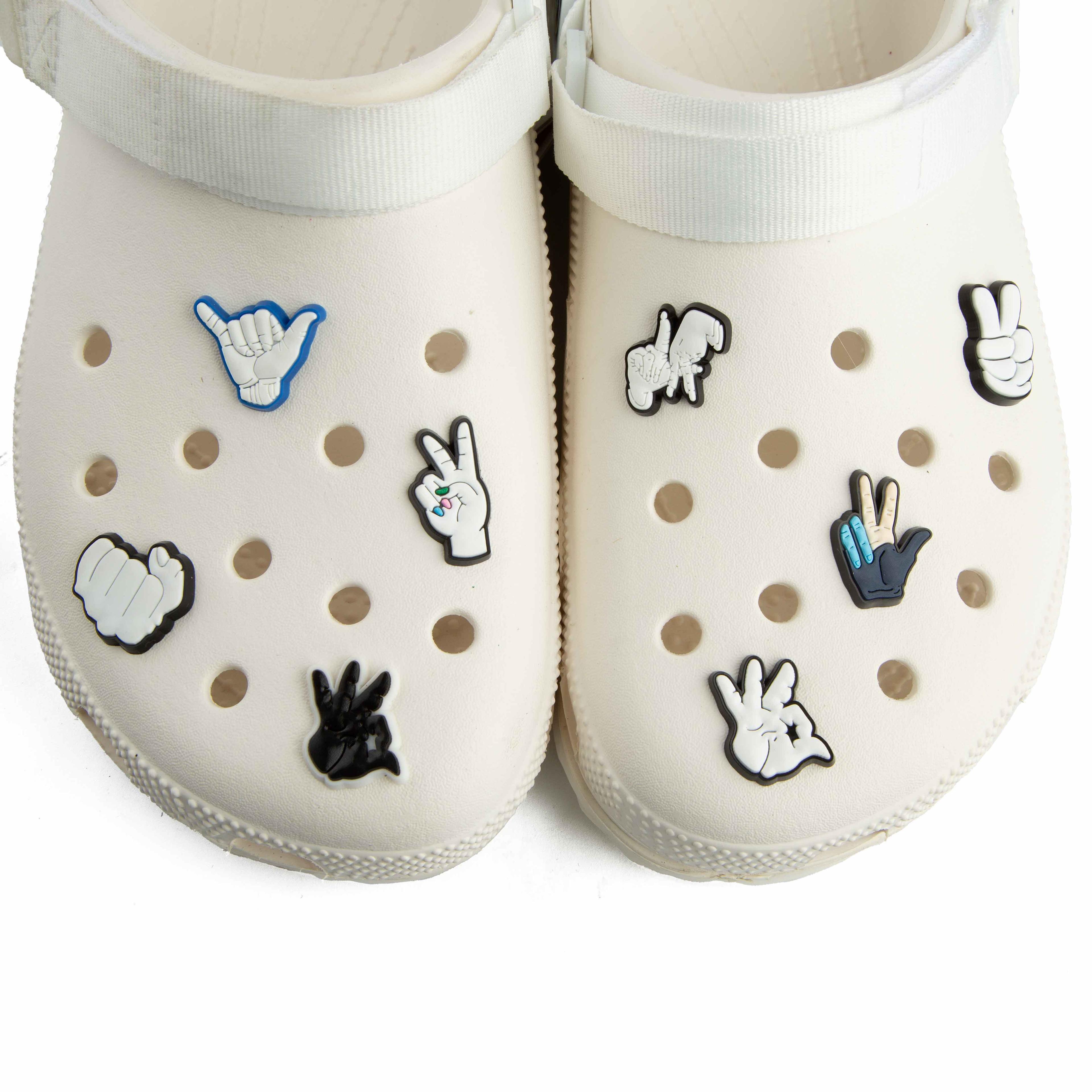 These are a pair of platform Crocs Classic Crush Clogs in an off-white or cream color. 