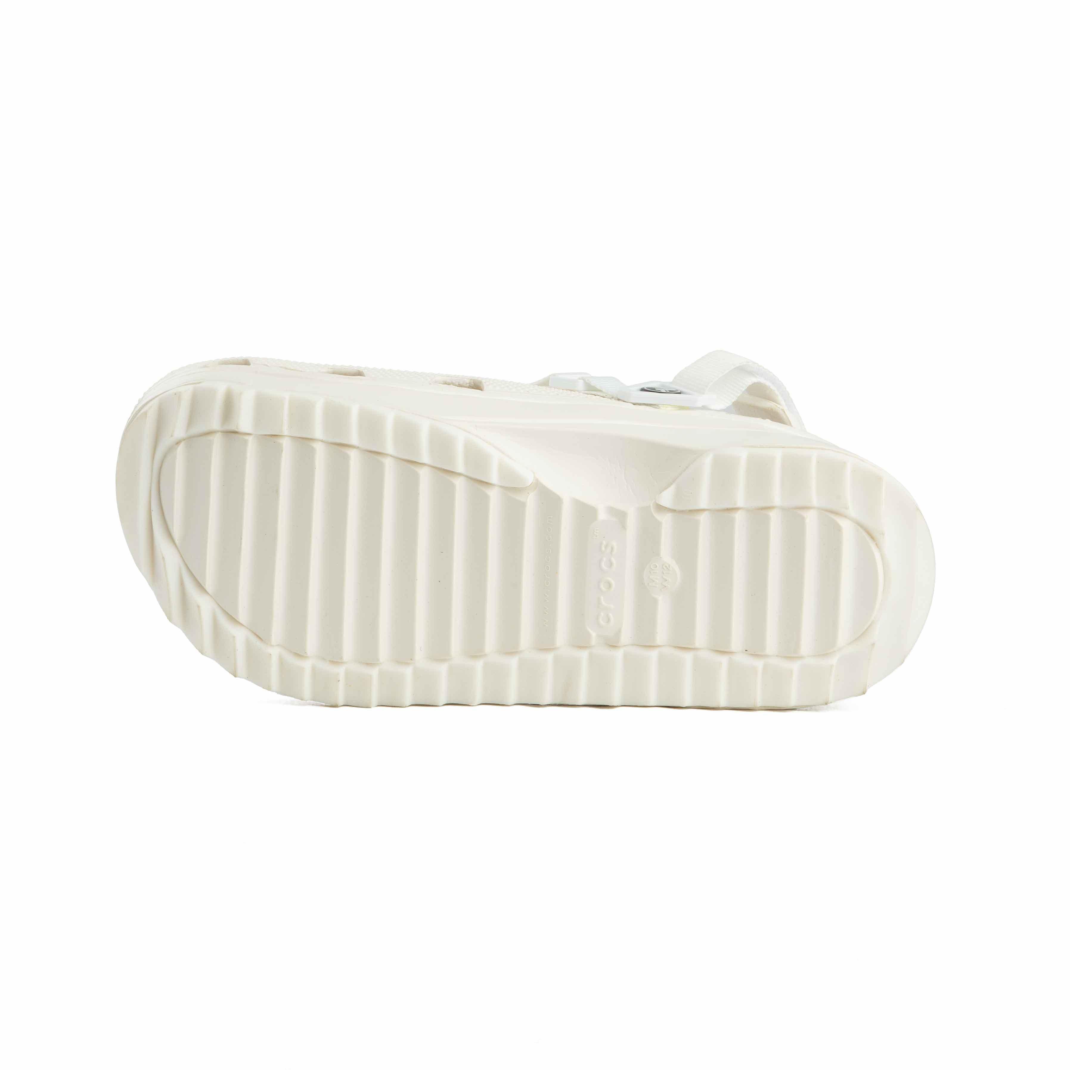 These are a pair of platform Crocs Classic Crush Clogs in an off-white or cream color. 