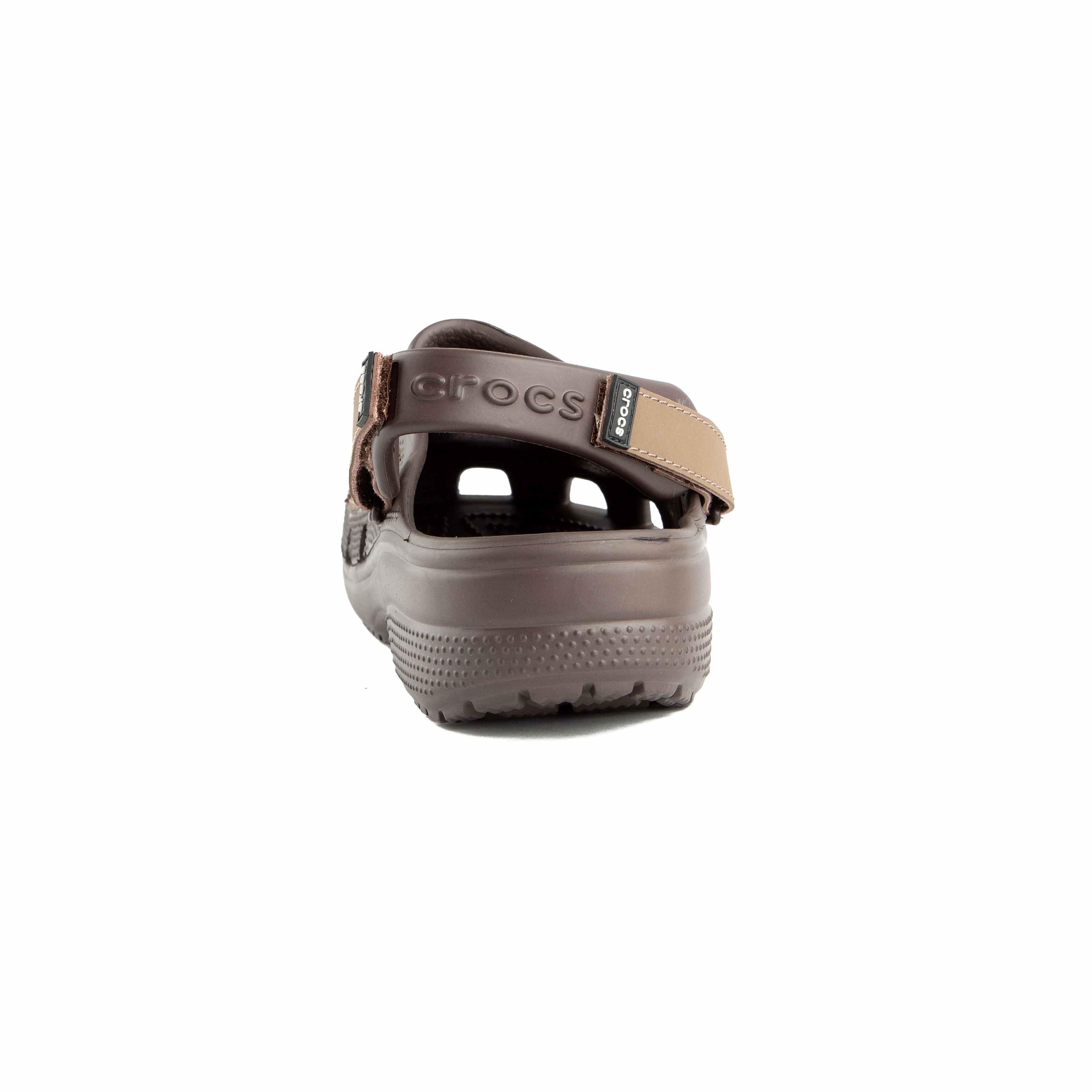 This is a pair of multi-toned brown Crocs clogs designed for rugged or water-friendly environments.