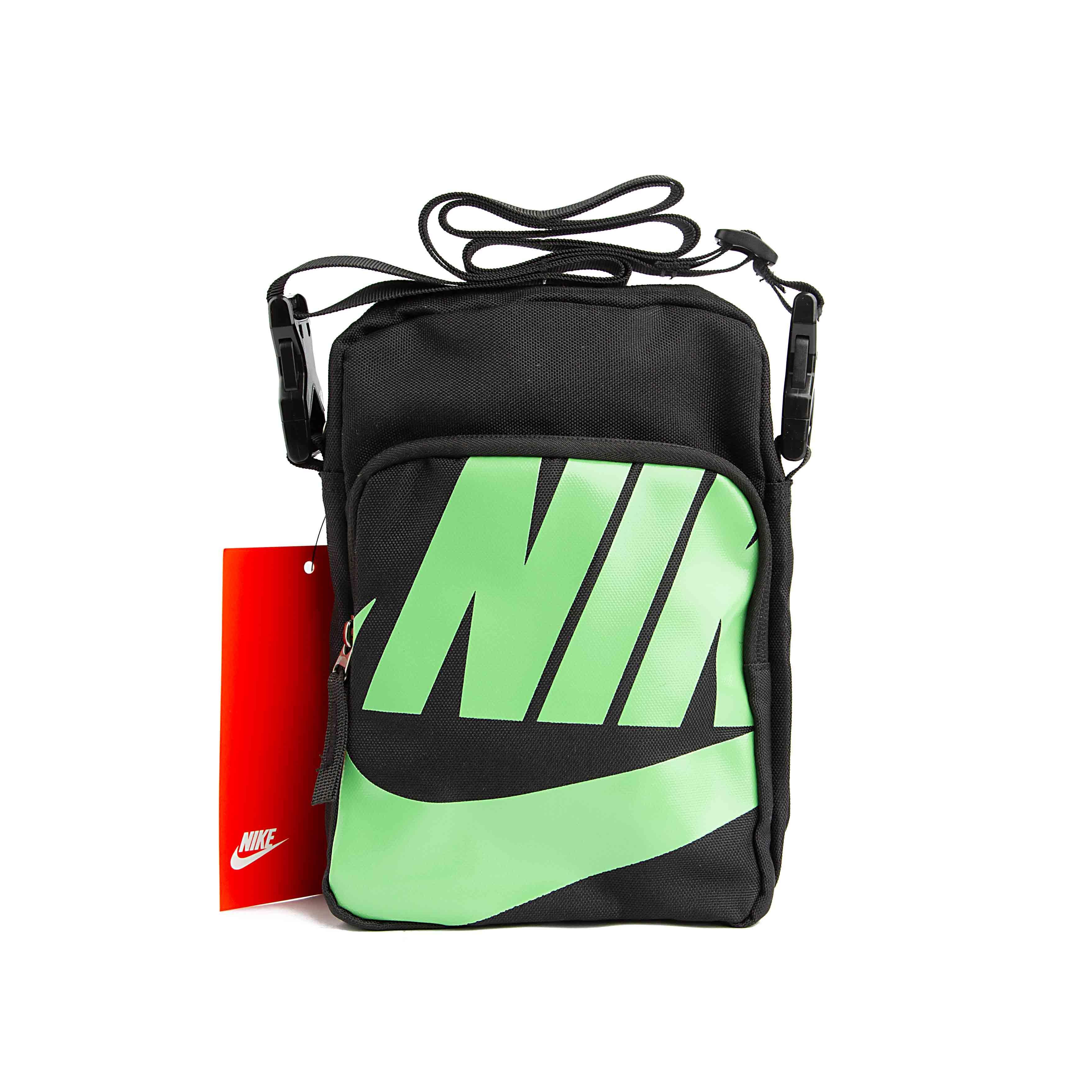 Black compact shoulder bag with adjustable strap and red product tag.