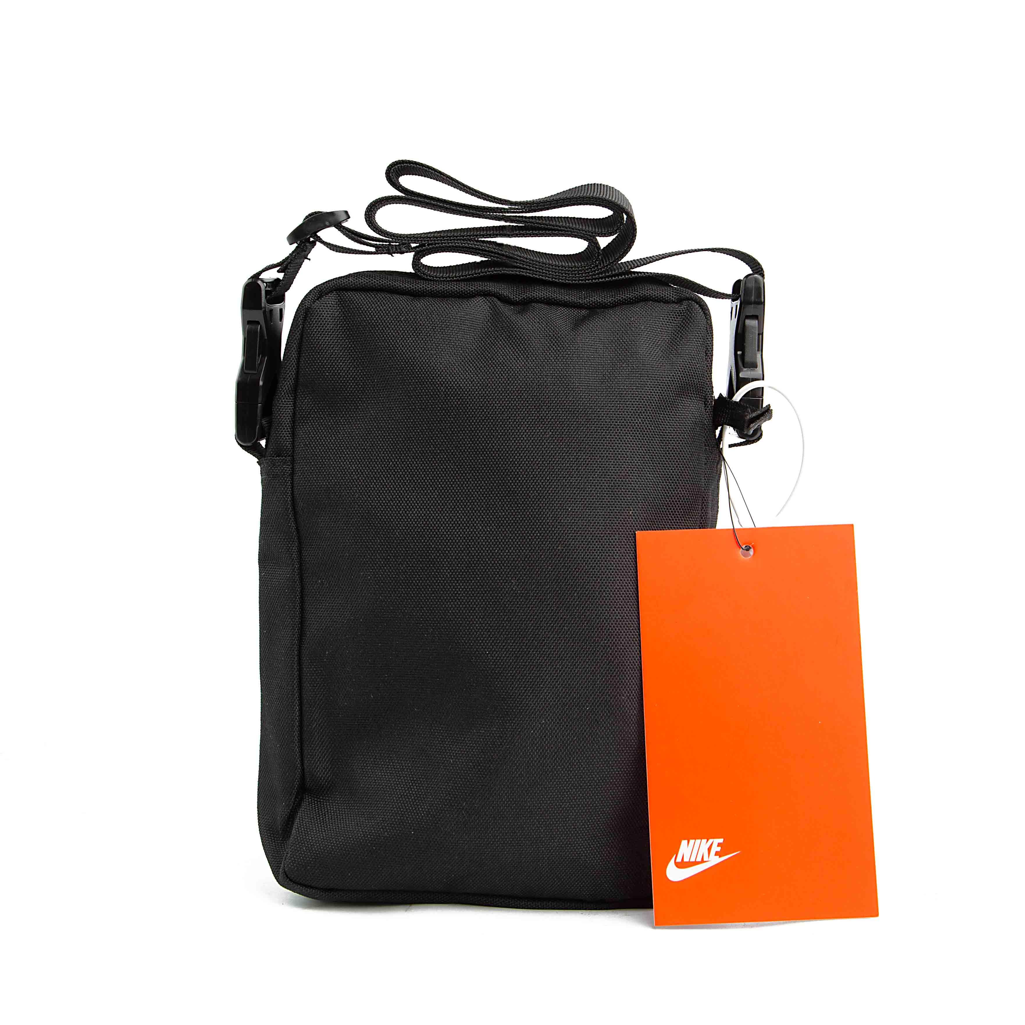 Black compact shoulder bag with adjustable strap and red product tag.