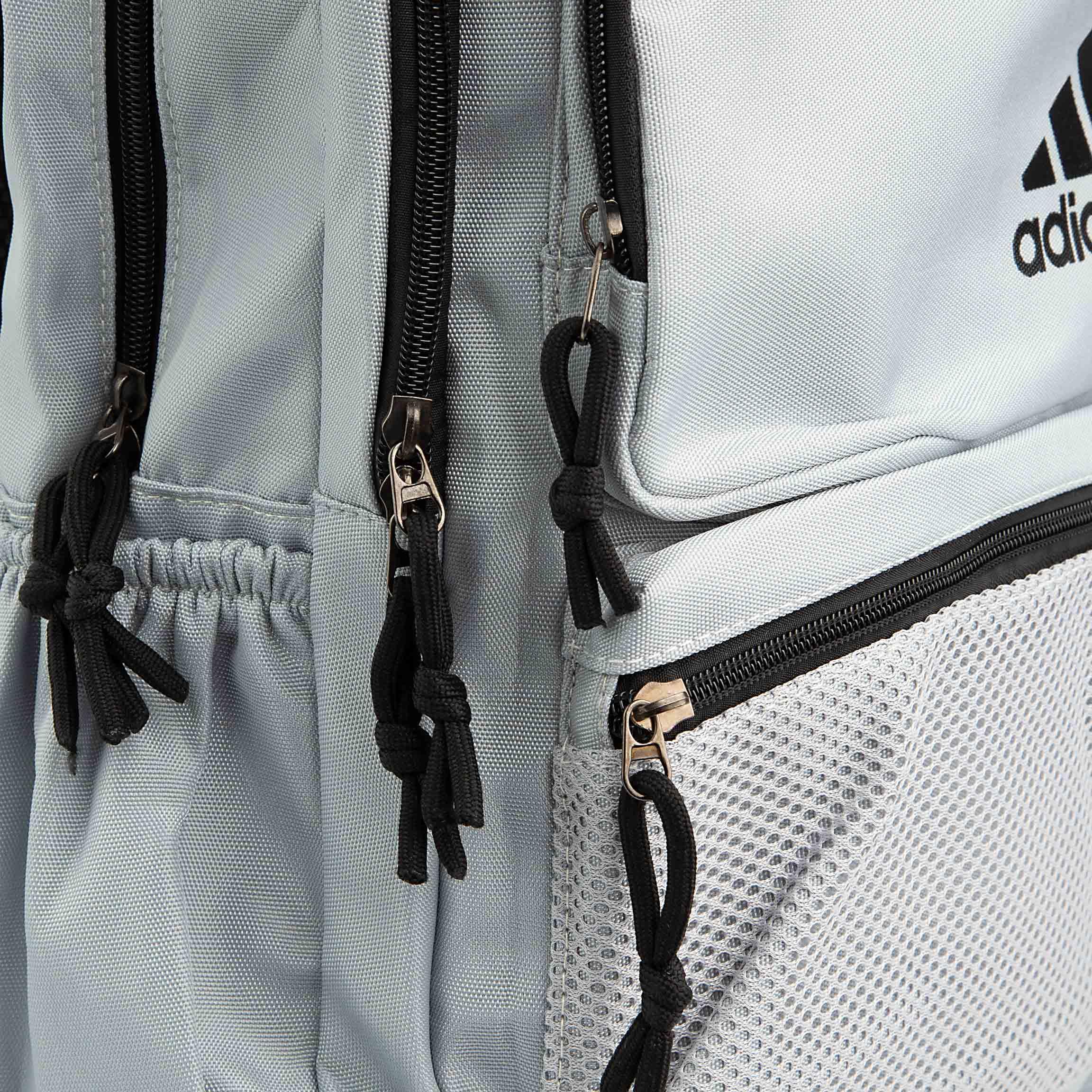 This is a minimalist, light grey backpack with a classic design. 
