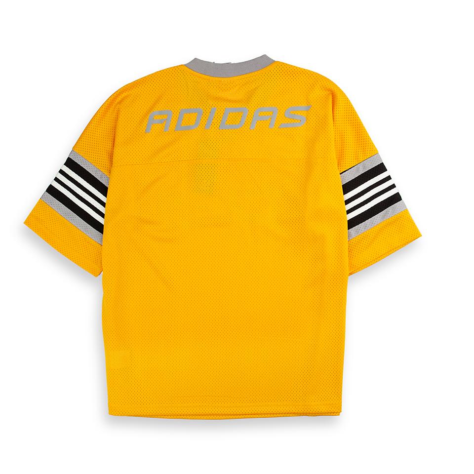 Adidas Originals mesh jersey. This unisex yellow jersey features a large "03" graphic, striped sleeves, and a lightweight feel for a sporty look