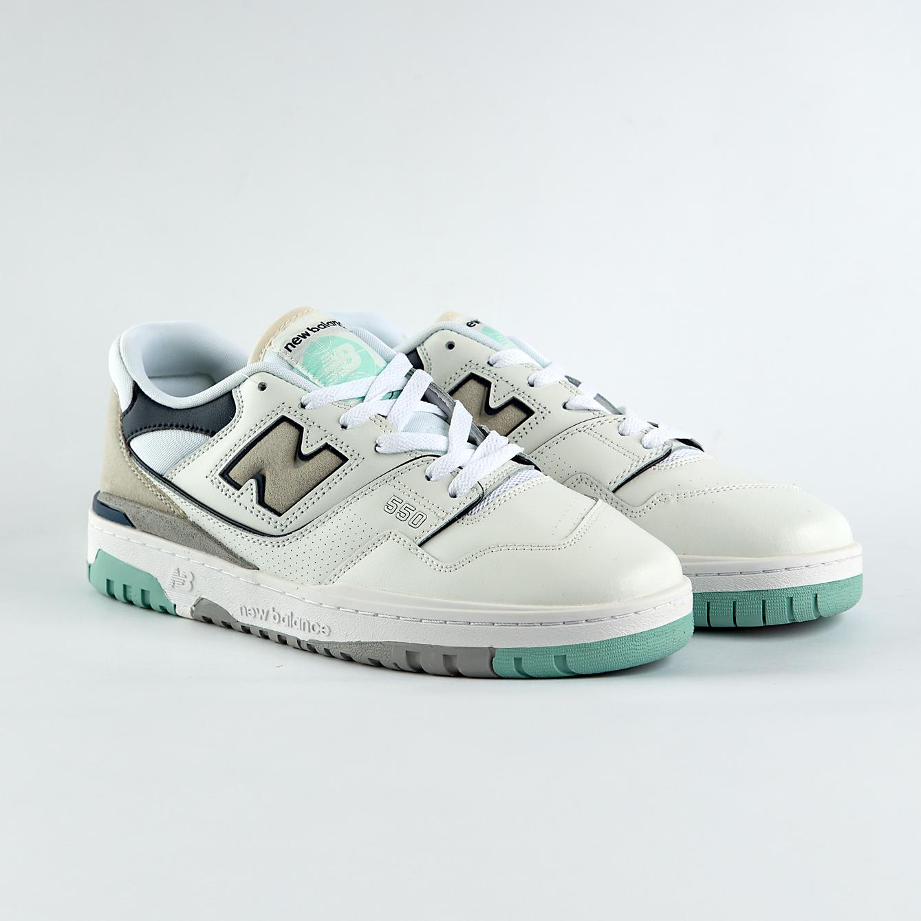 New Balance 550 sneakers in off-white with mint green, taupe, and gray accents. A retro low-top shoe for men and women.