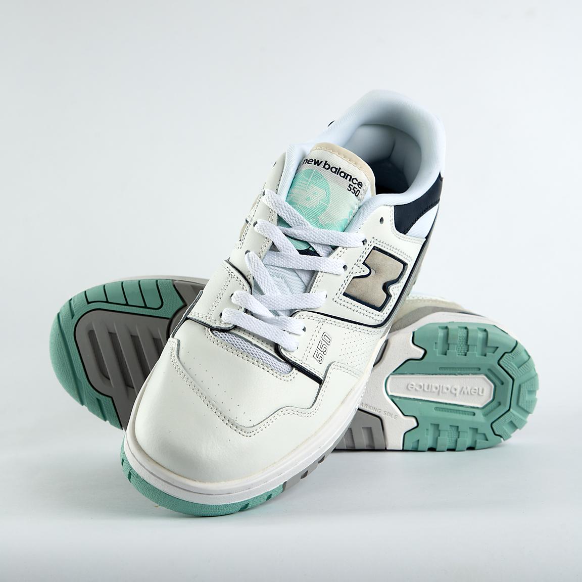 New Balance 550 sneakers in off-white with mint green, taupe, and gray accents. A retro low-top shoe for men and women.