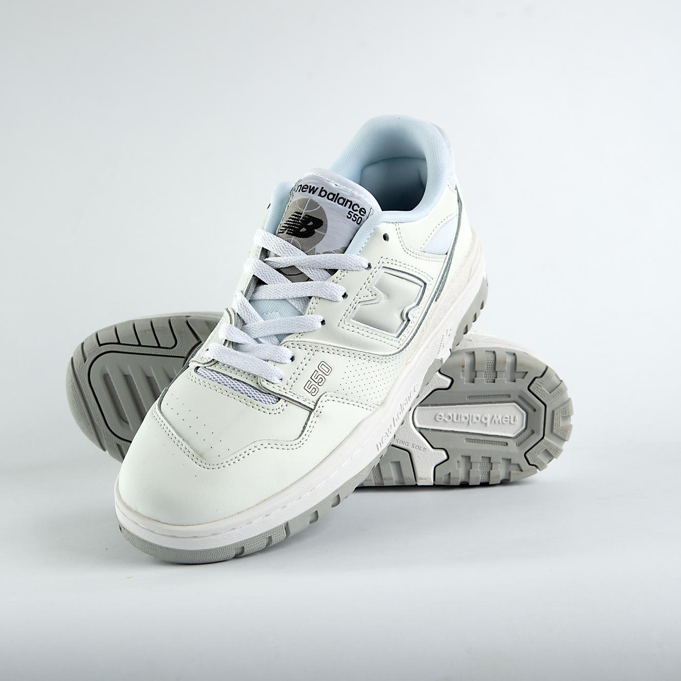    New Balance 550 sneakers in an off-white and light gray colorway. A classic low-top style with a minimalist look for men and women.