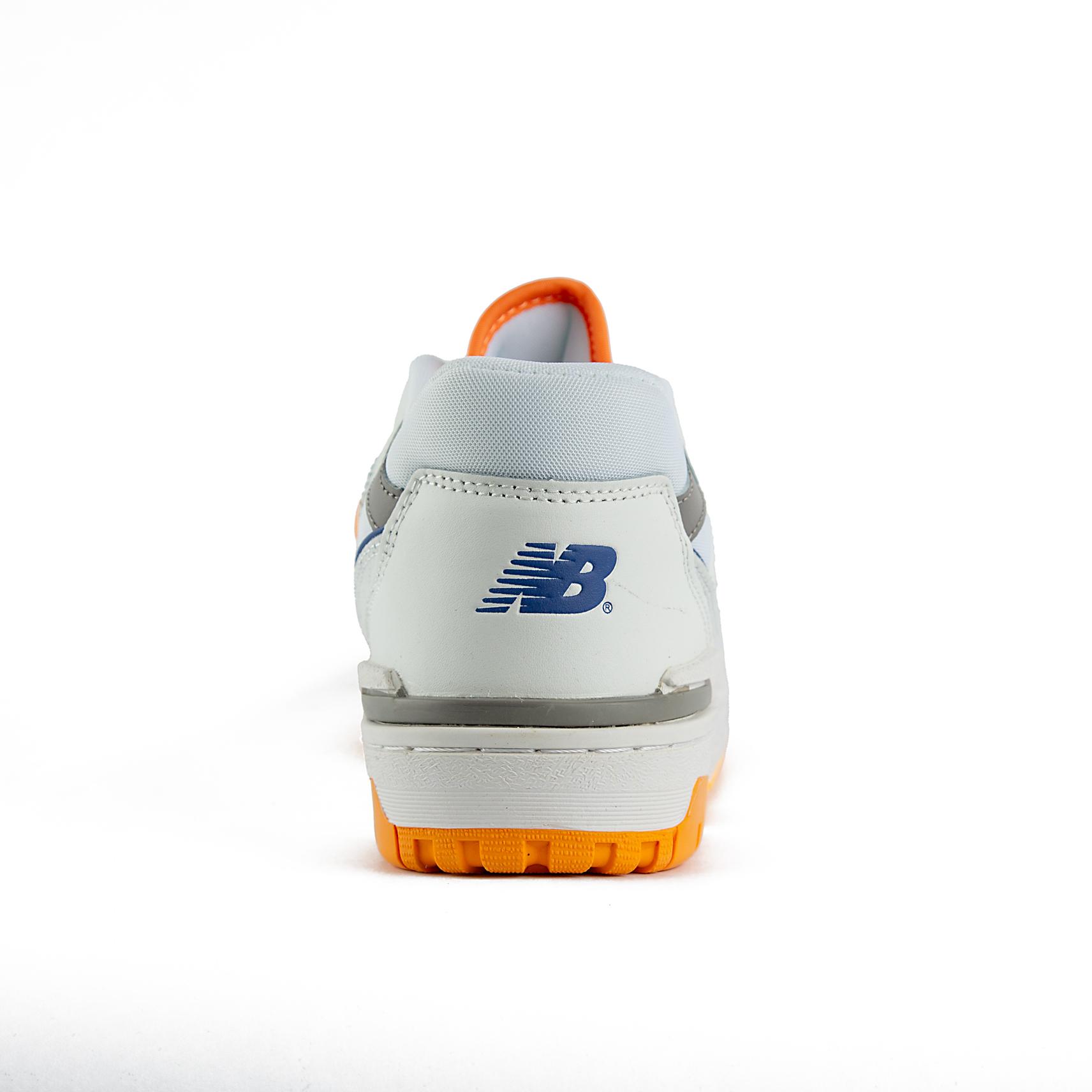 New Balance 550 sneakers in white with orange and gray details. A retro low-top shoe suitable for men and women.