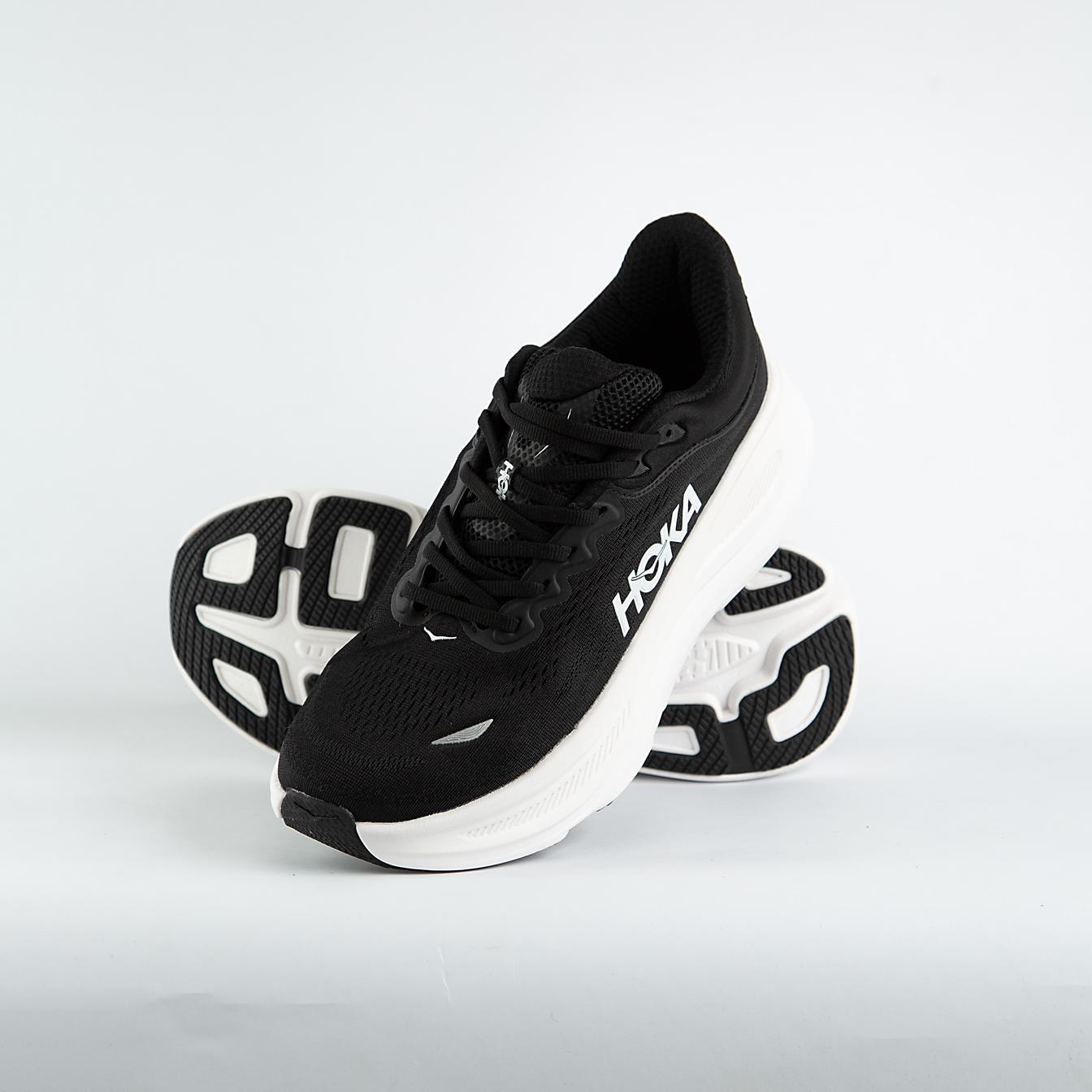 A pair of black and white Hoka Bondi 9 Sneakers cushioned road running shoes, known for maximum comfort and support for everyday runs and walks.