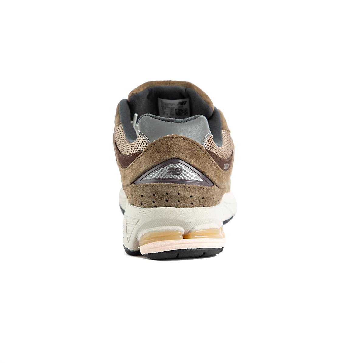 Pair of New Balance 2002R brown and beige sneakers on a white background