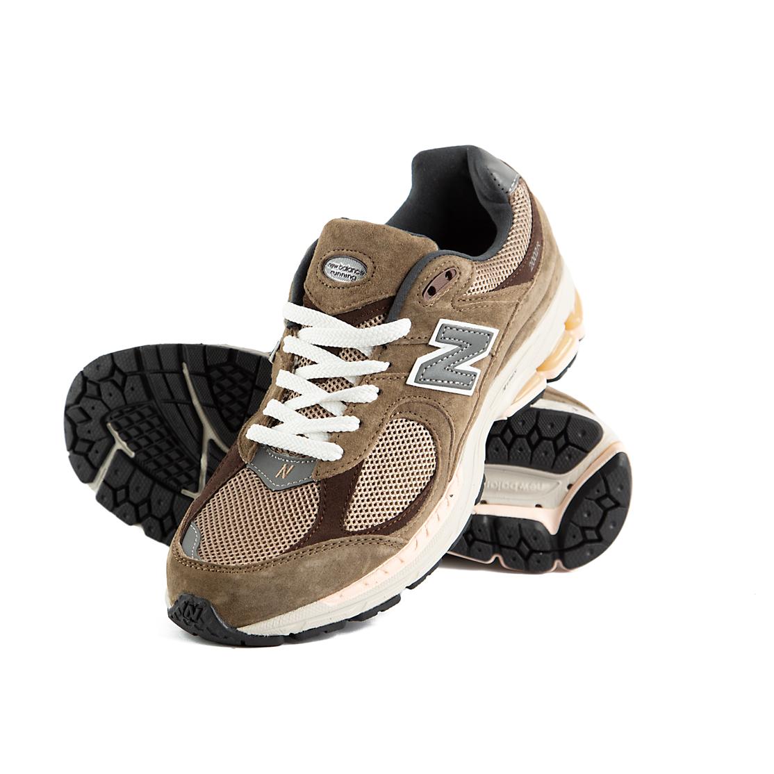 Pair of New Balance 2002R brown and beige sneakers on a white background