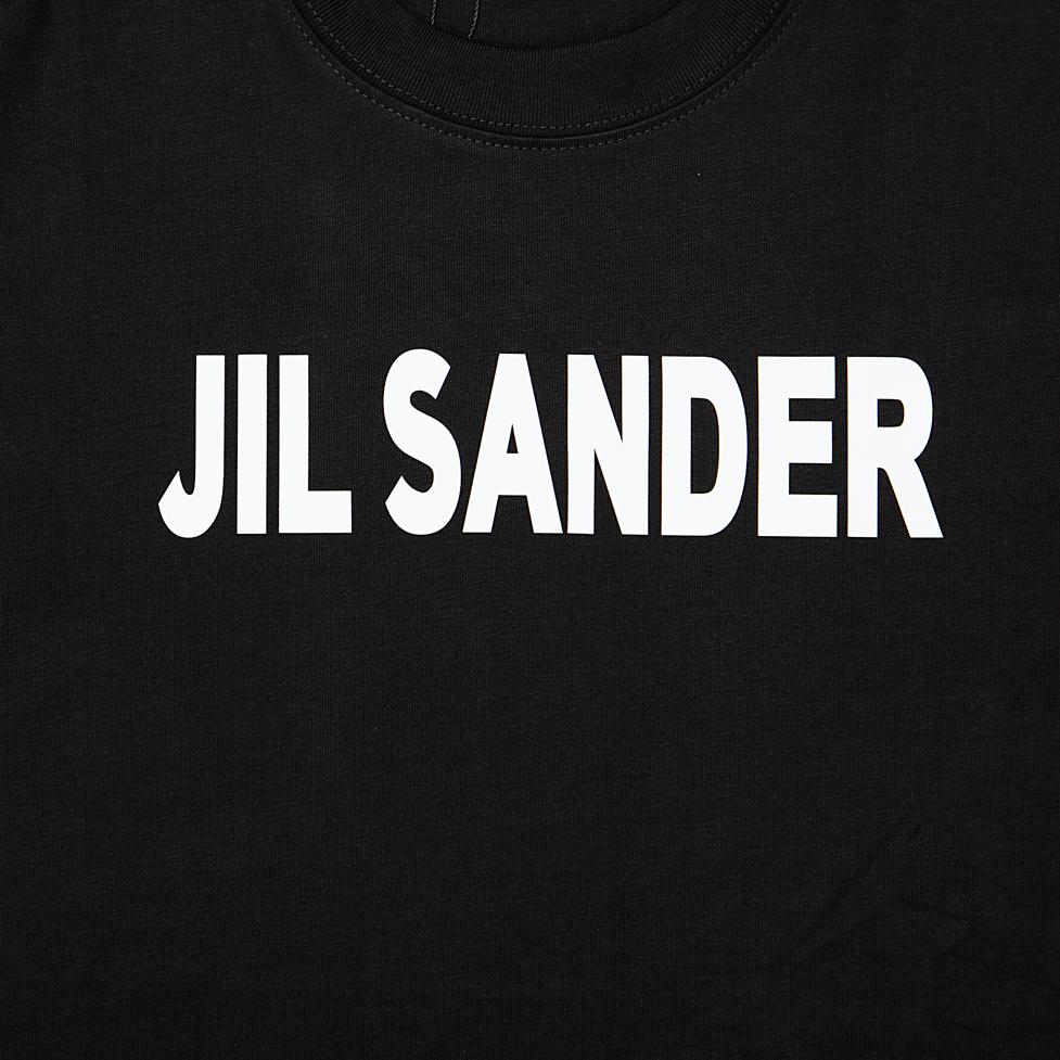This is a minimalist, luxury short-sleeved T-shirt from the German fashion house Jil Sander. It embodies the brand's signature clean, understated aesthetic.