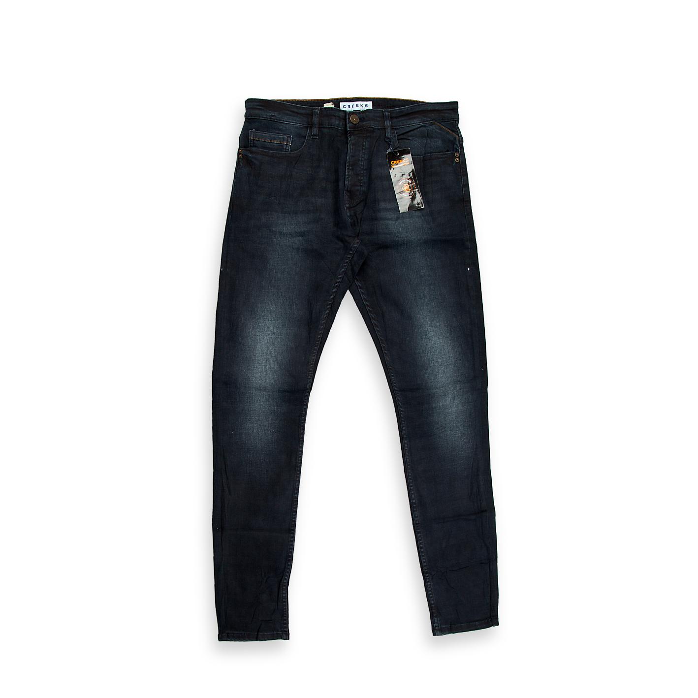 A modern pair of men's slim-tapered jeans featuring a stylish washed black (or faded charcoal) colour.
