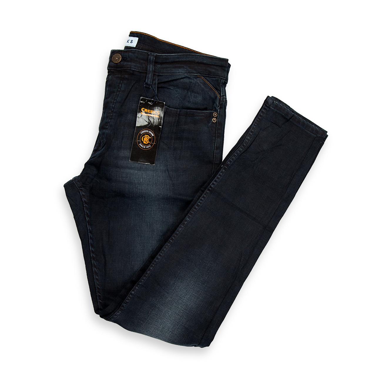 A modern pair of men's slim-tapered jeans featuring a stylish washed black (or faded charcoal) colour.