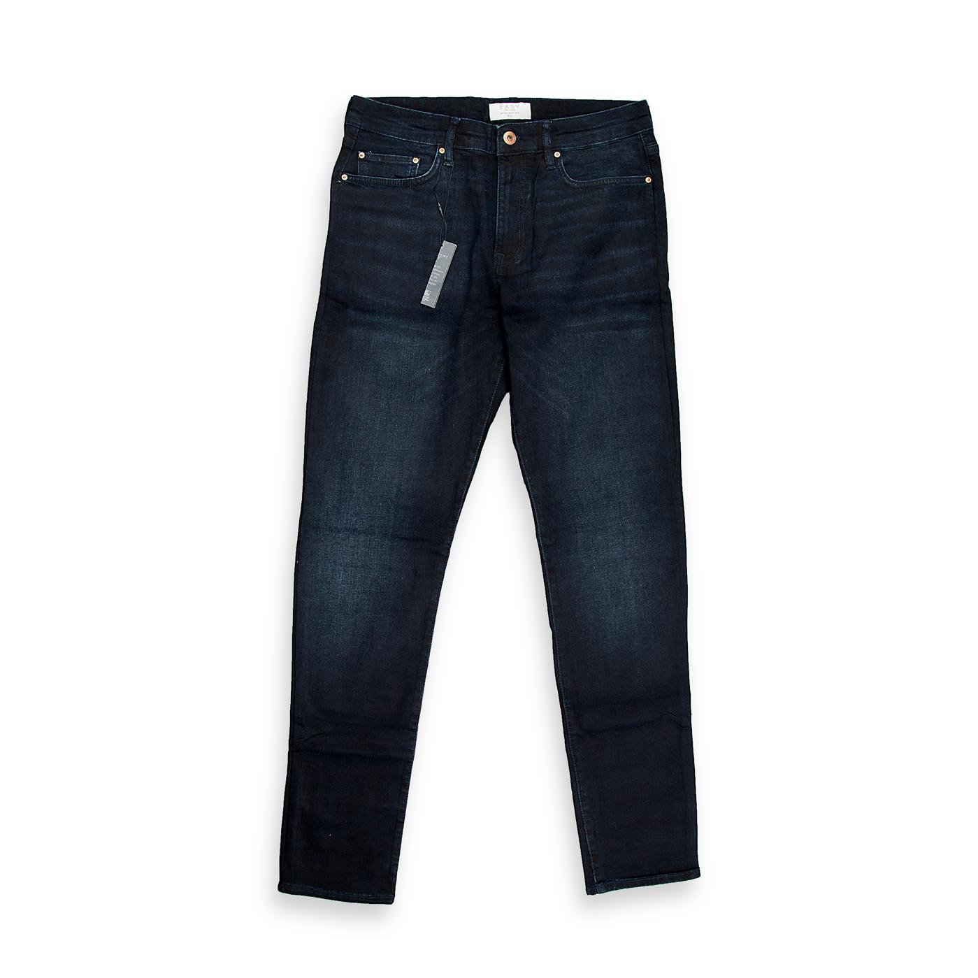 A foundational piece for any wardrobe, this is a timeless pair of men's jeans in a very dark, rich indigo wash. The wash is deep and consistent, suggesting a dressier, more refined aesthetic compared to a highly distressed or faded pair.