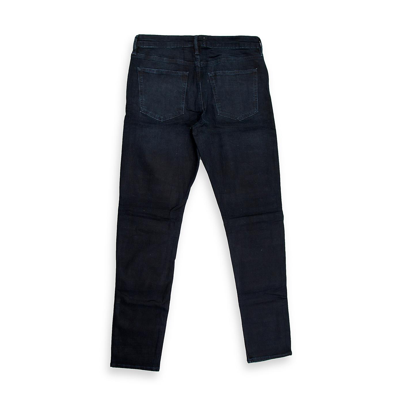 A foundational piece for any wardrobe, this is a timeless pair of men's jeans in a very dark, rich indigo wash. The wash is deep and consistent, suggesting a dressier, more refined aesthetic compared to a highly distressed or faded pair.