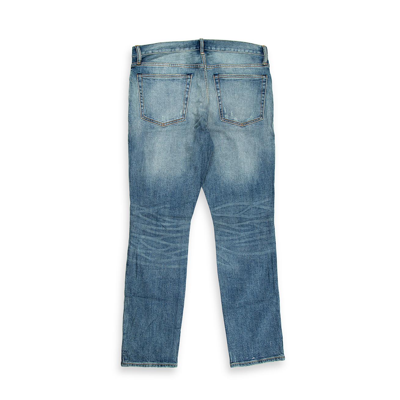 A bold, contemporary pair of men's jeans with a light-blue wash and heavy-duty distressing.