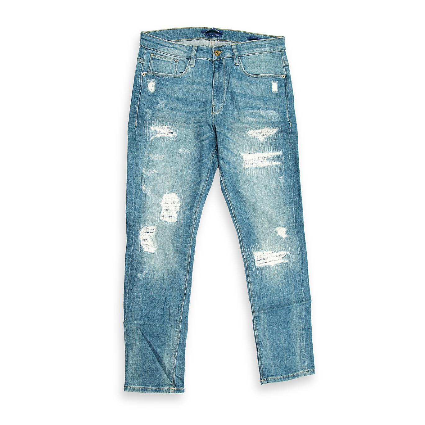 These are a pair of slim-fit jeans characterized by a light/medium blue acid wash (or heavily bleached wash), which gives the denim a highly faded, streaky appearance.