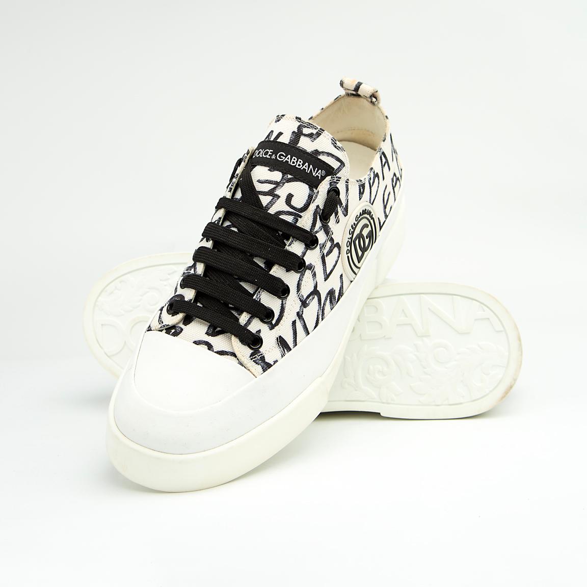 These are contemporary Dolce & Gabbana low-top sneakers featuring a classic tennis-shoe silhouette updated with bold, high-fashion branding. 