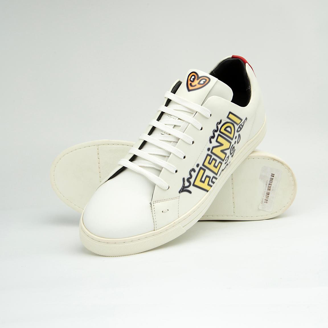 The White Tiger Skate Low is a clean, modern, low-top trainer with a luxury streetwear edge. It is crafted from smooth, premium white leather and features a distinctive black and white graphic drawing on the side panel, resembling a stylized tiger or abstract artwork.