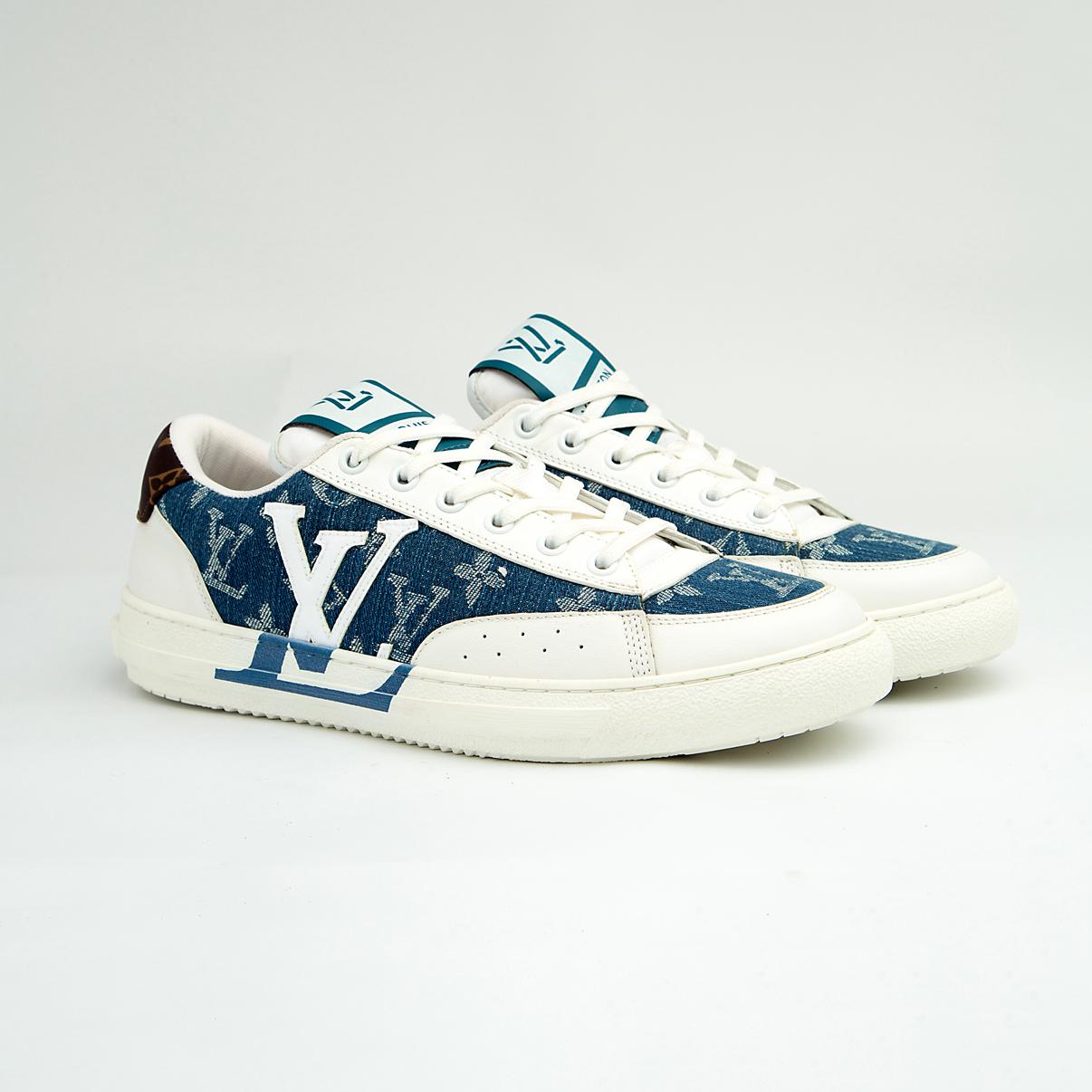 The Denim Riviera Ace is a high-fashion, low-top sneaker built on a classic court silhouette. It features a unique upper constructed from blue denim-style canvas or leather boldly printed with the recognizable Louis Vuitton Monogram pattern.