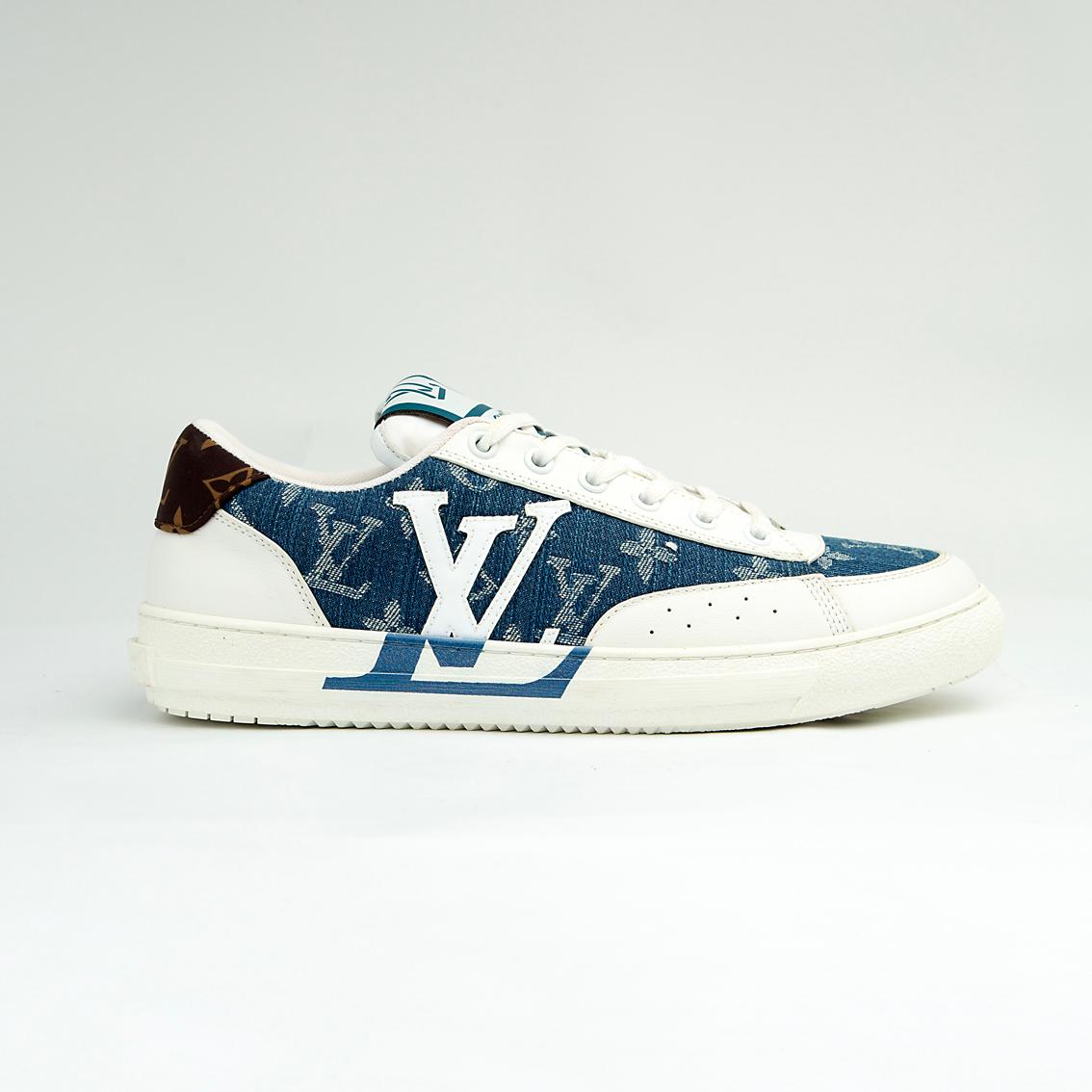 The Denim Riviera Ace is a high-fashion, low-top sneaker built on a classic court silhouette. It features a unique upper constructed from blue denim-style canvas or leather boldly printed with the recognizable Louis Vuitton Monogram pattern.