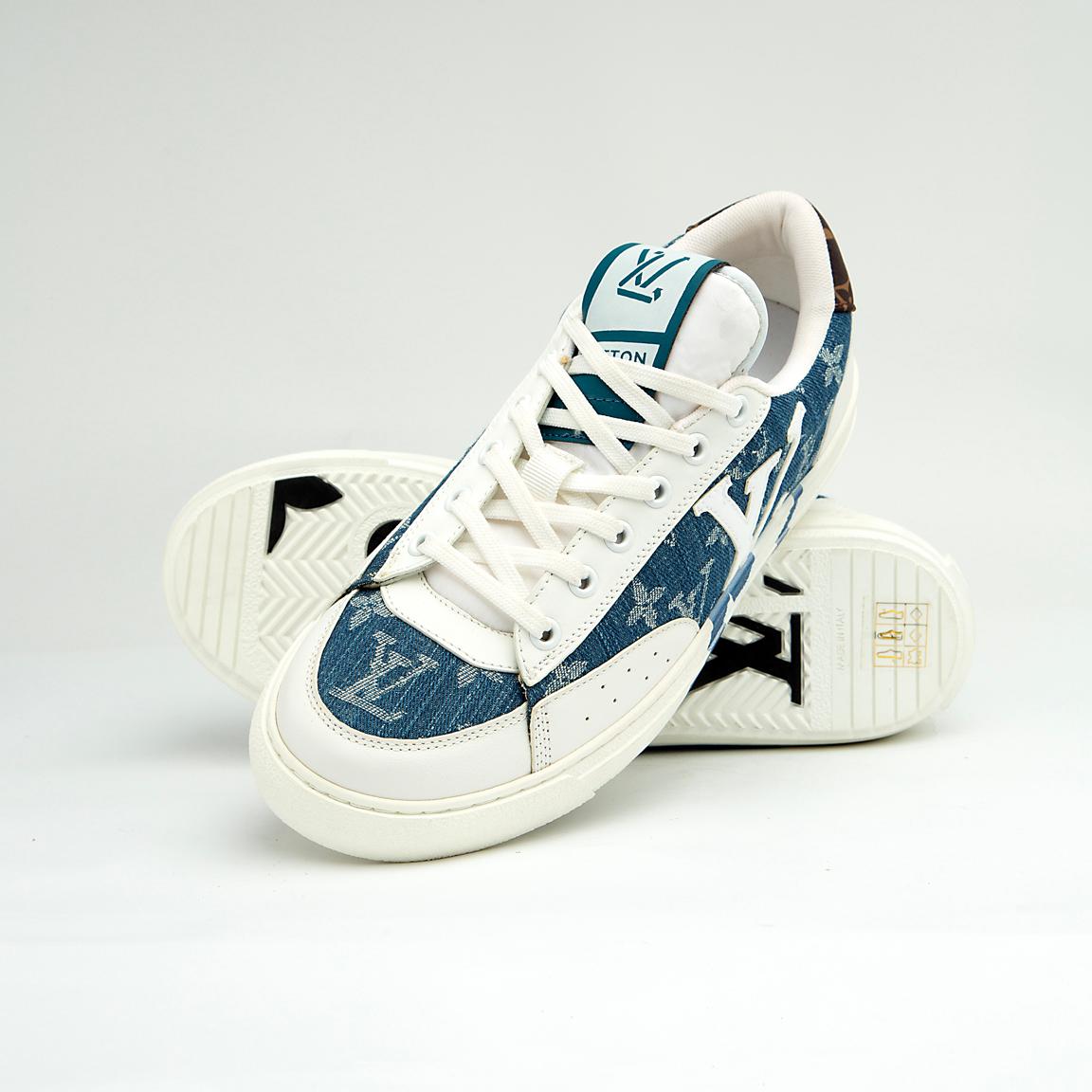 The Denim Riviera Ace is a high-fashion, low-top sneaker built on a classic court silhouette. It features a unique upper constructed from blue denim-style canvas or leather boldly printed with the recognizable Louis Vuitton Monogram pattern.