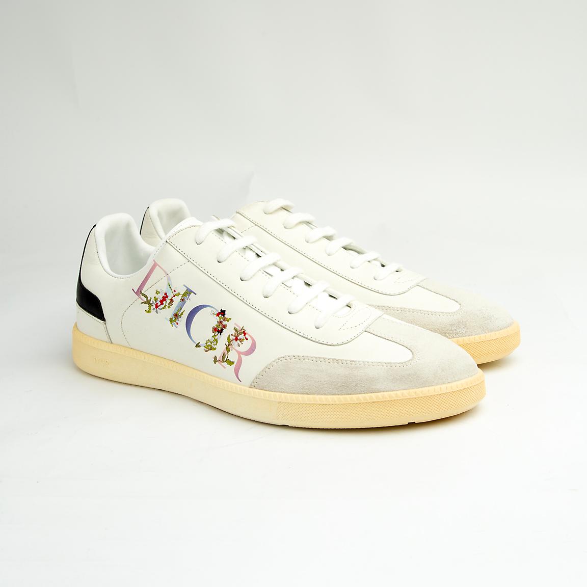 Crafted from smooth white calfskin leather, the shoe is accented by a subtle cream suede toe cap.