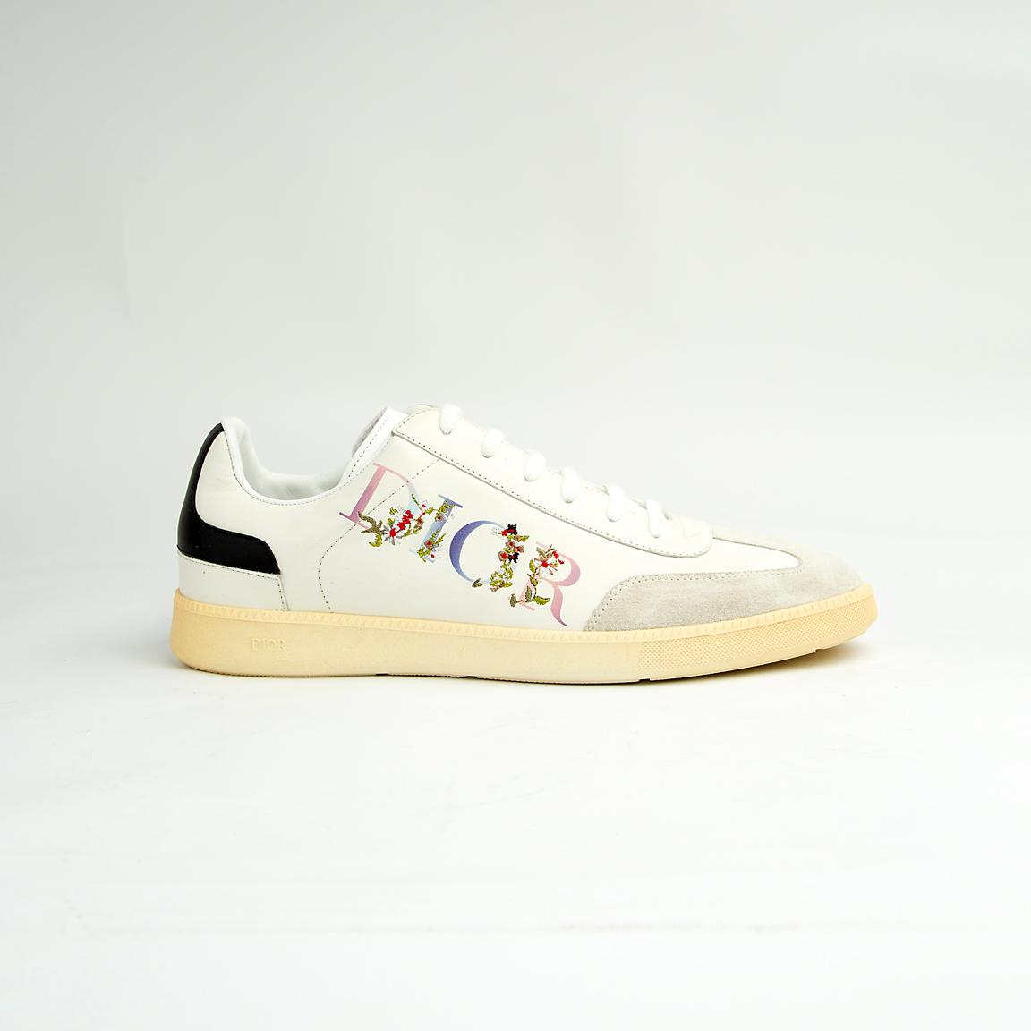 Crafted from smooth white calfskin leather, the shoe is accented by a subtle cream suede toe cap.