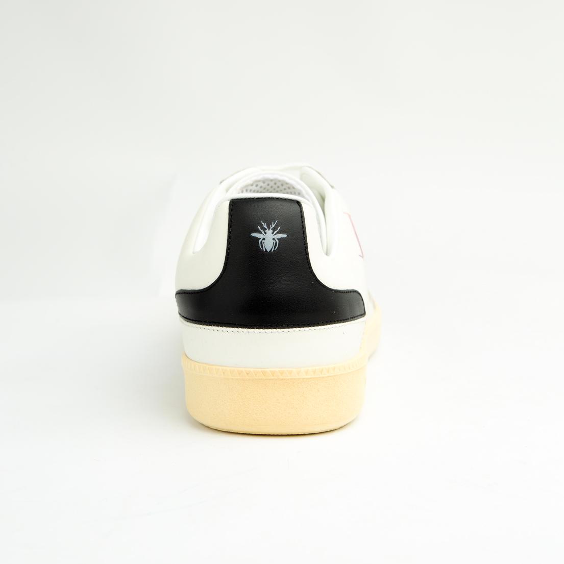 Crafted from smooth white calfskin leather, the shoe is accented by a subtle cream suede toe cap.