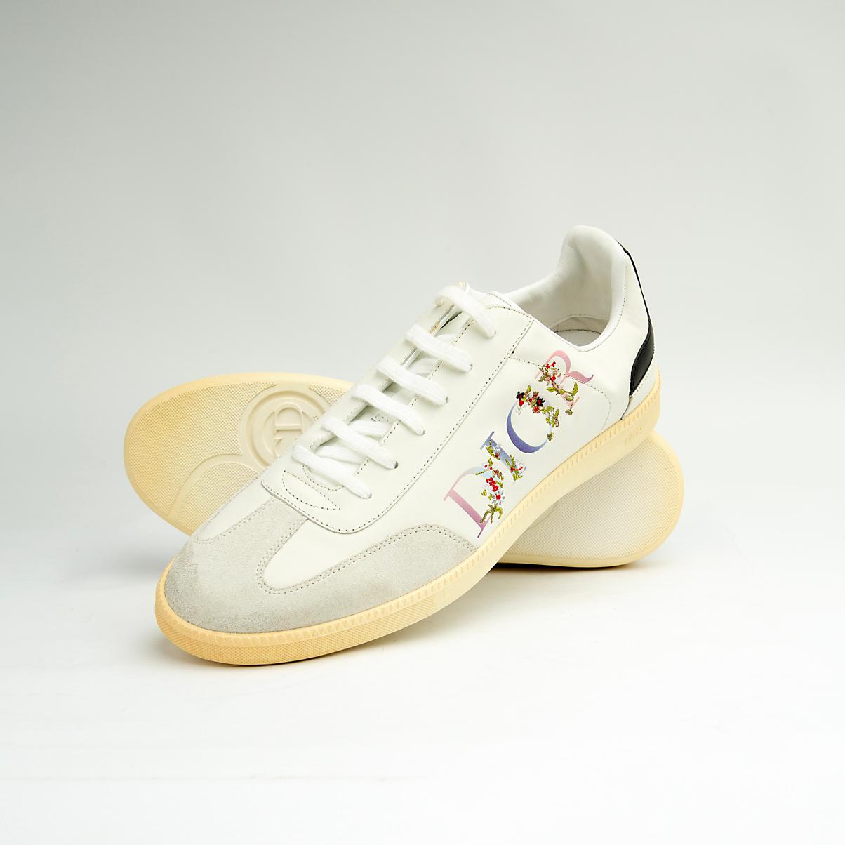 Crafted from smooth white calfskin leather, the shoe is accented by a subtle cream suede toe cap.